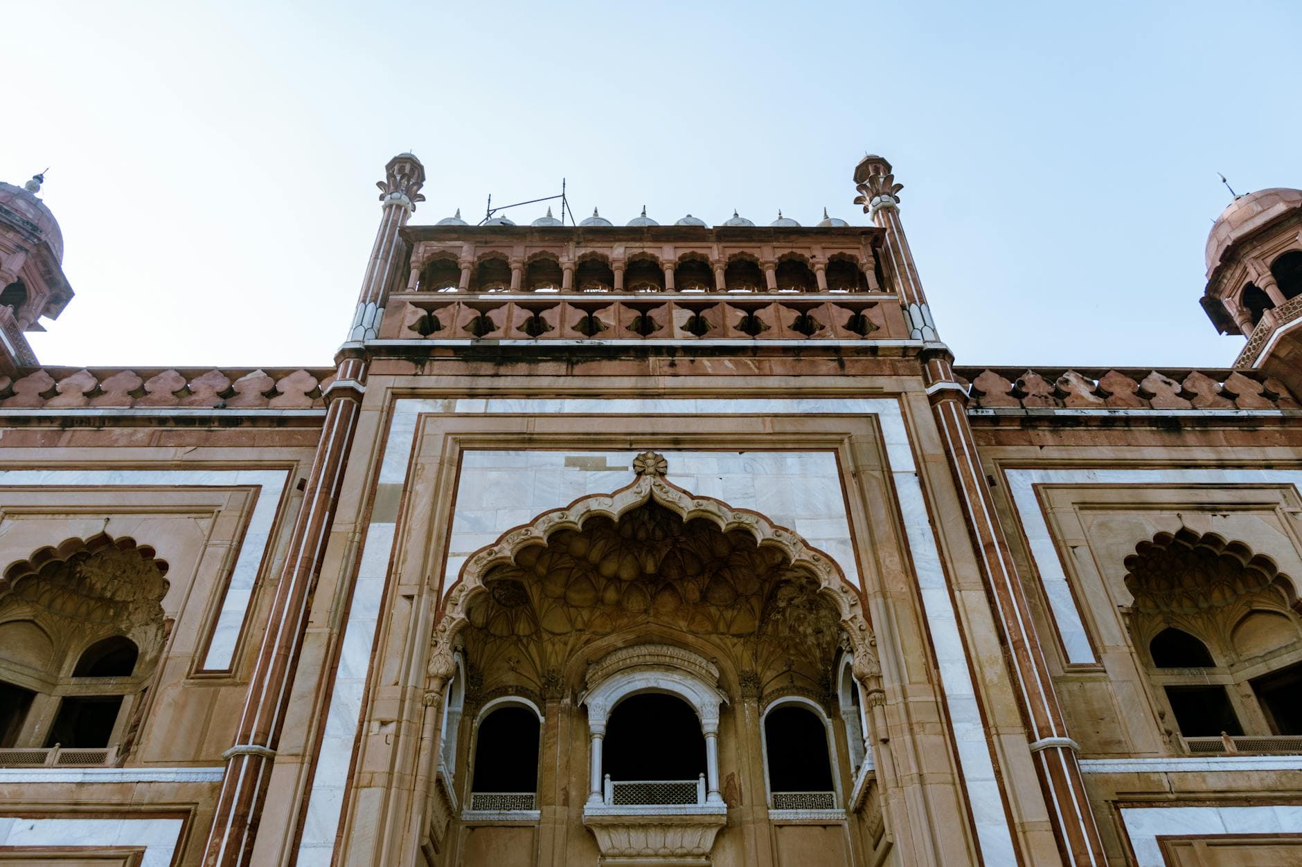 A detailed view of the stunning Safdarjung Tomb facade in New Delhi, showcasing intricate Mughal architecture.