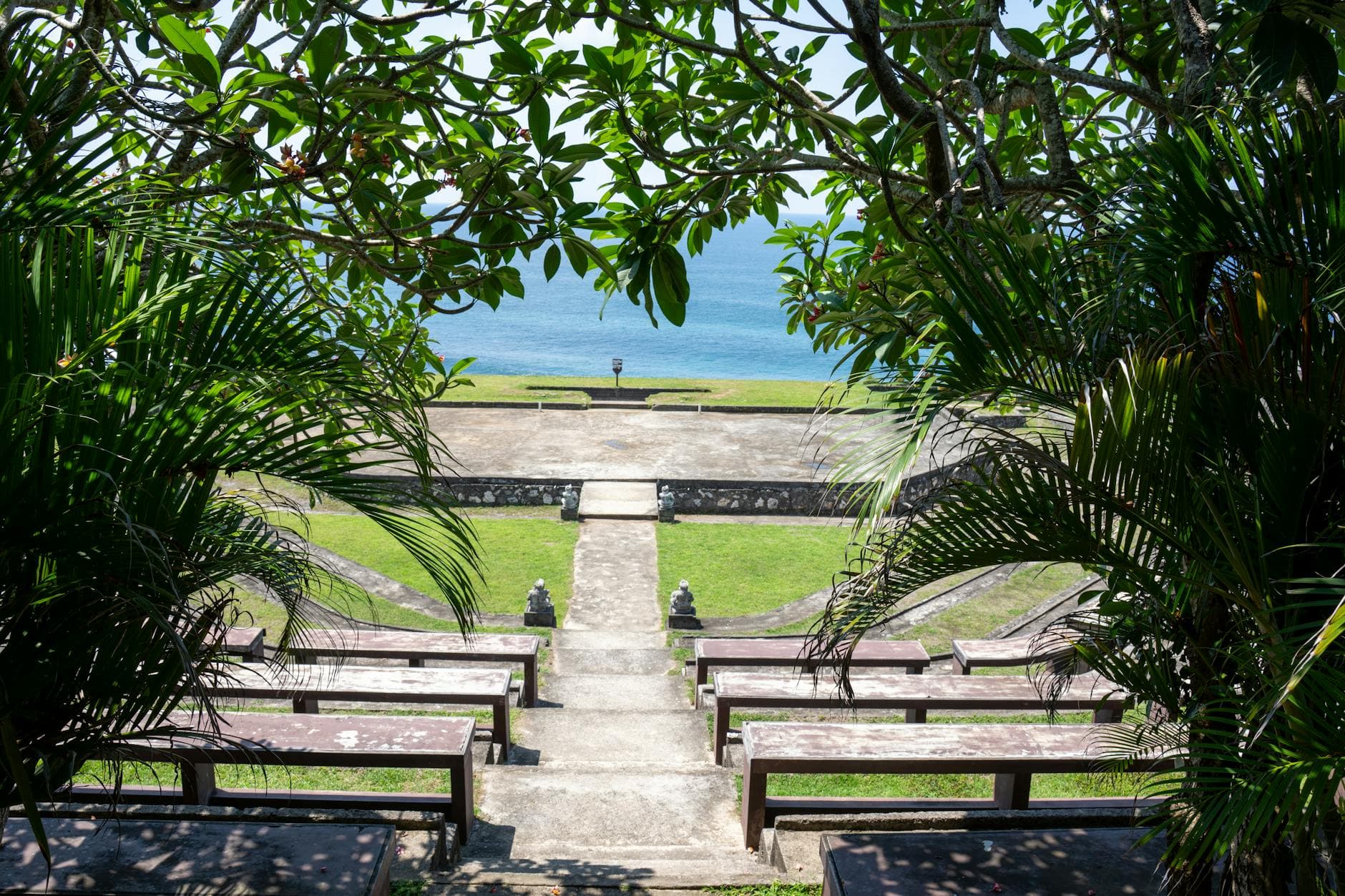 Beautiful amphitheater with ocean view framed by lush greenery in Bali.