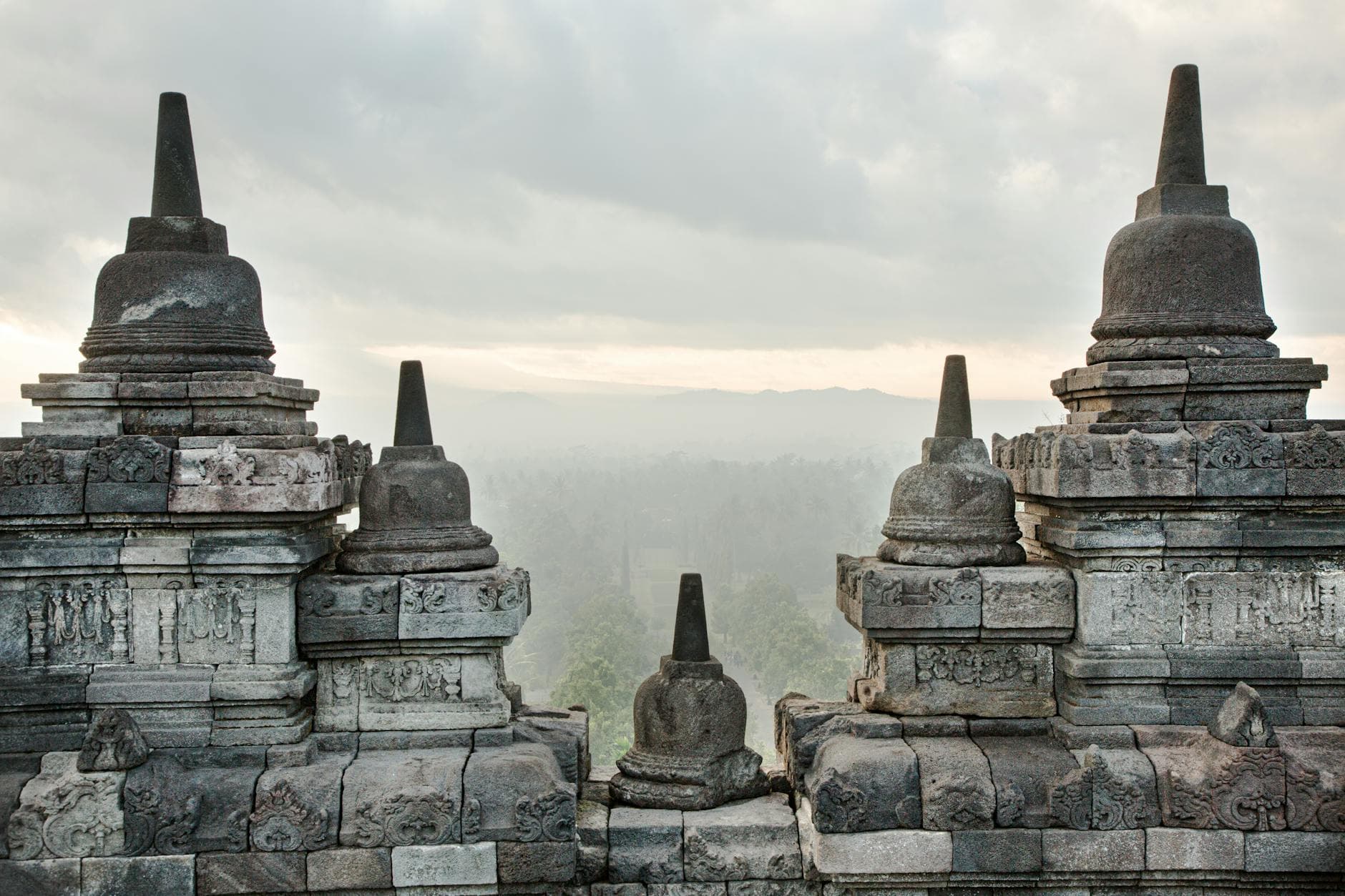 Stunning foggy landscape view of Borobudur Temple, a UNESCO World Heritage site in Indonesia.