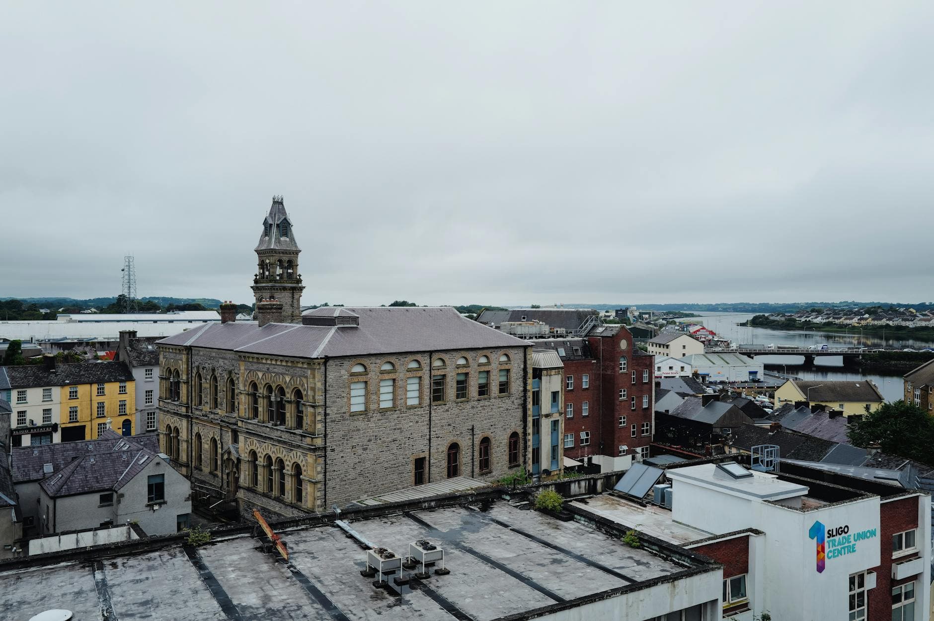 Aerial view of historic architecture in Sligo, Ireland with scenic landscape background.