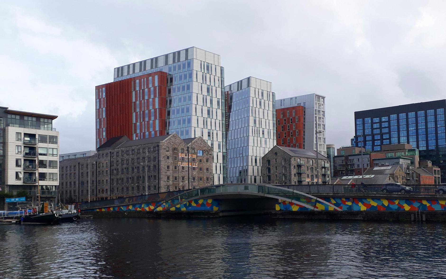 Contemporary architecture and colorful bridge over river in Dublin
