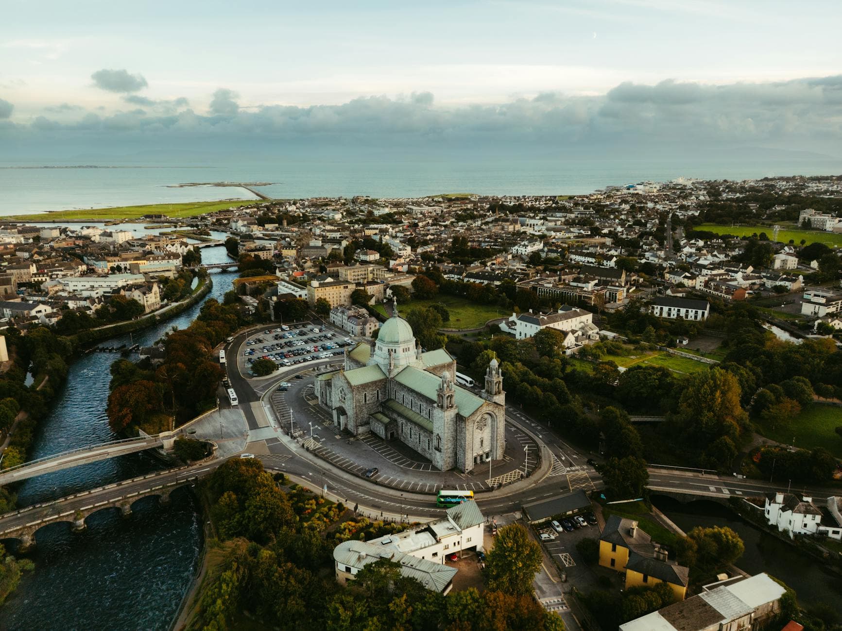 A breathtaking aerial view of Galway, Ireland featuring St. Nicholas' Cathedral and surrounding landscape.
