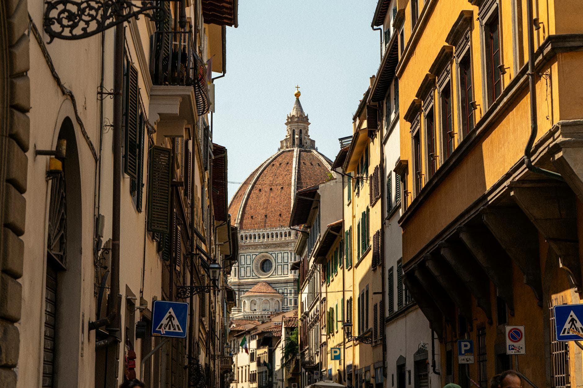 A picturesque street in Florence with a view of the iconic cathedral dome, capturing Italian charm.