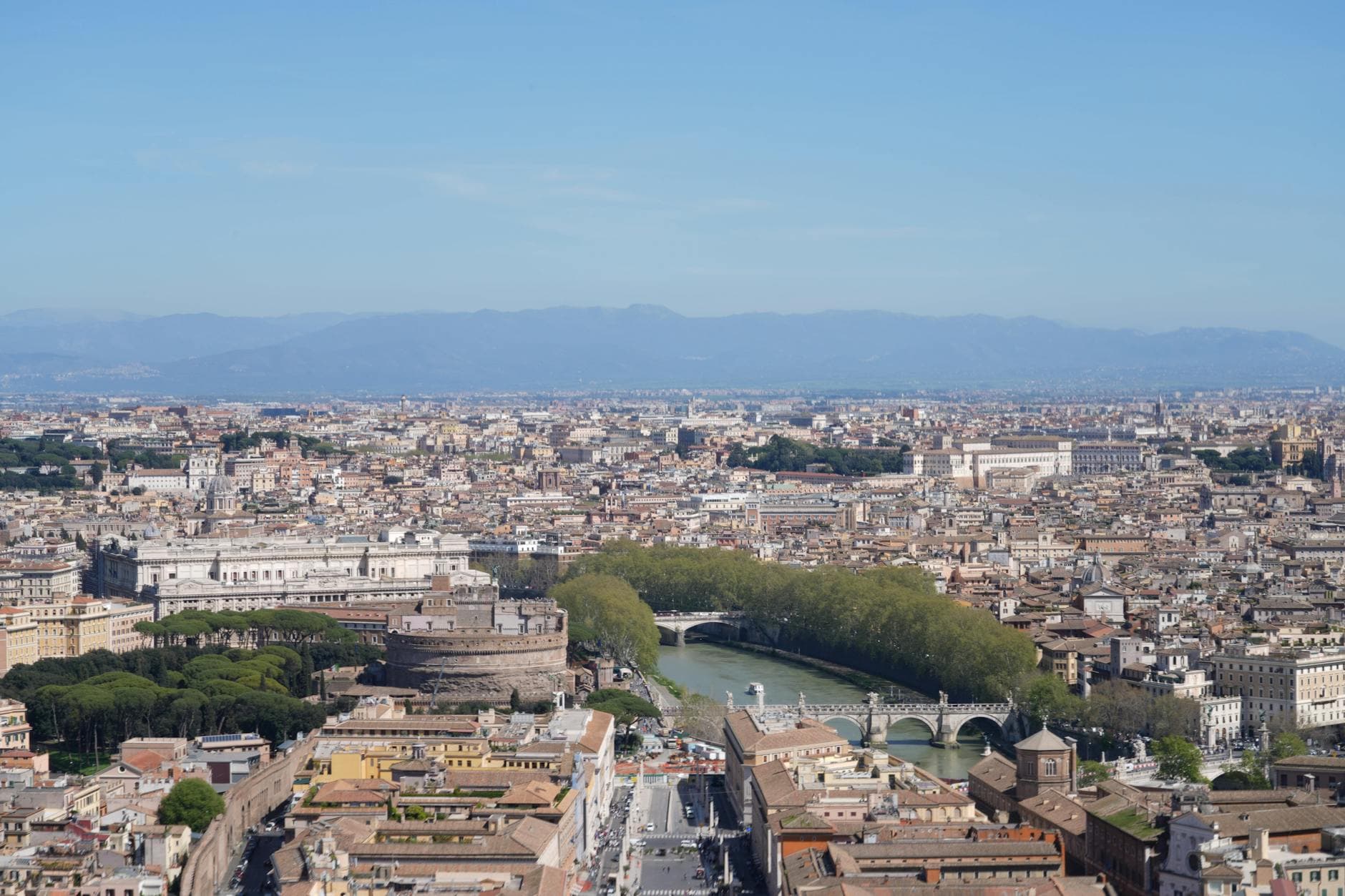 A breathtaking aerial view of Rome featuring Castel Sant'Angelo and the Tiber River, showcasing the city's iconic landmarks.