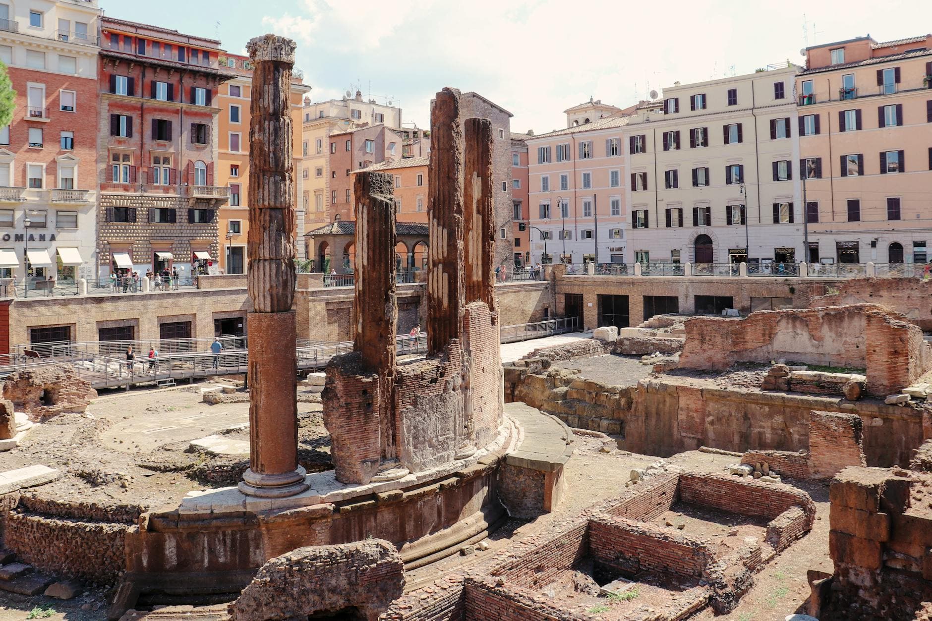 Explore the ancient Roman ruins of Largo di Torre Argentina in Rome during a sunny day.