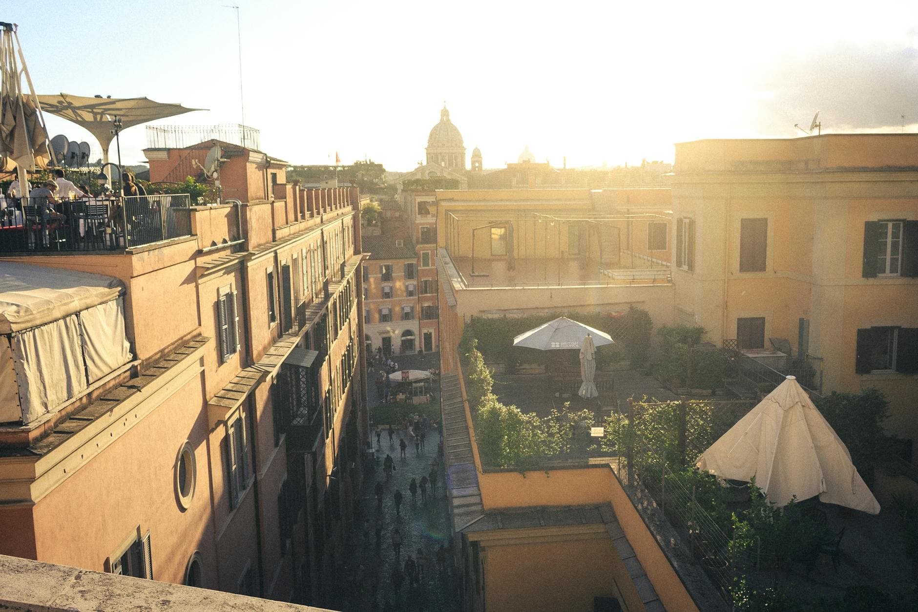 A stunning sunset view over Rome's rooftops, showcasing the city's historic architecture and vibrant atmosphere.
