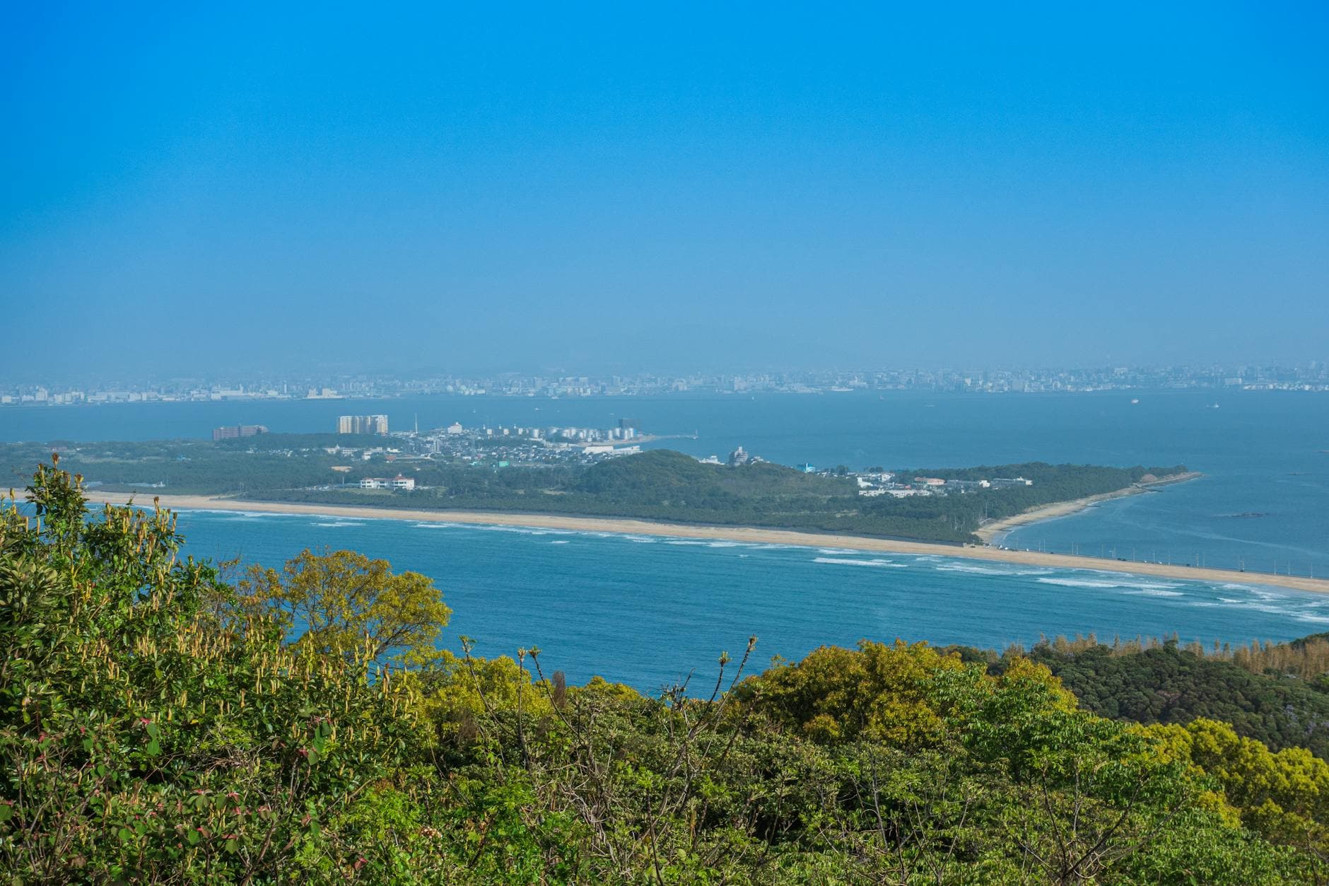 Breathtaking Fukuoka skyline with coastal view and lush greenery, showcasing Japan's natural beauty.