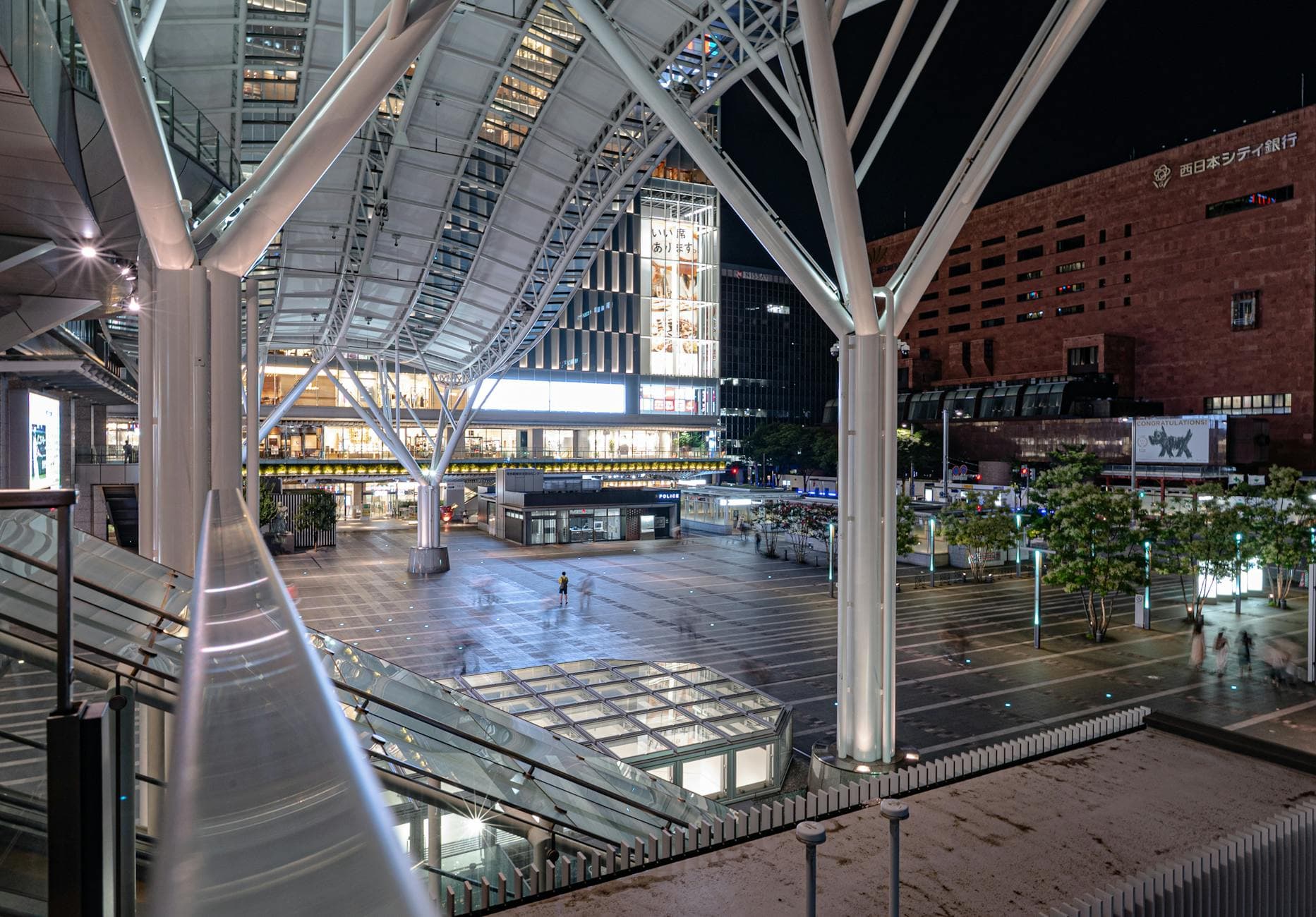 Explore the modern architectural marvel of Hakata Station in Fukuoka, Japan, captured at night.