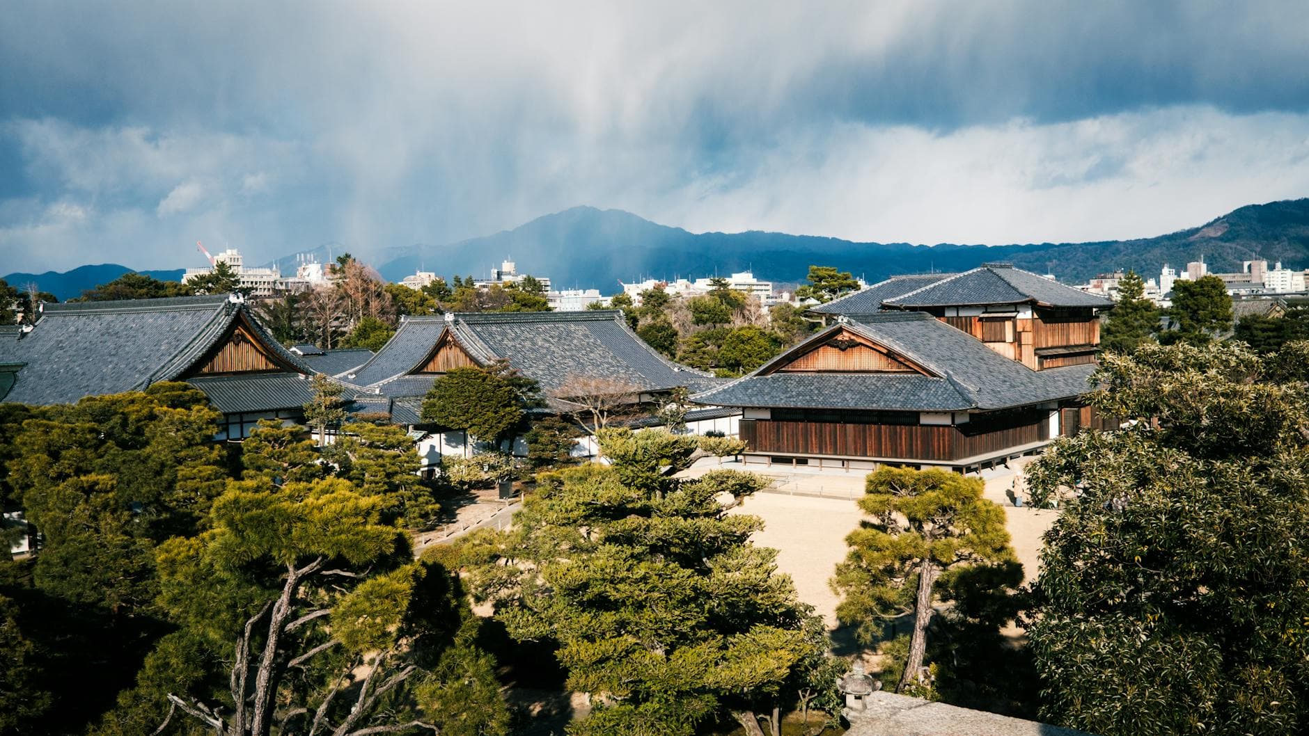 A scenic view of traditional Japanese buildings amidst lush greenery in Kyoto.