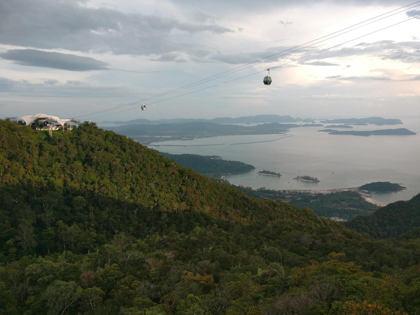 Breathtaking aerial view of Langkawi's cable car with lush forests and serene coastline.