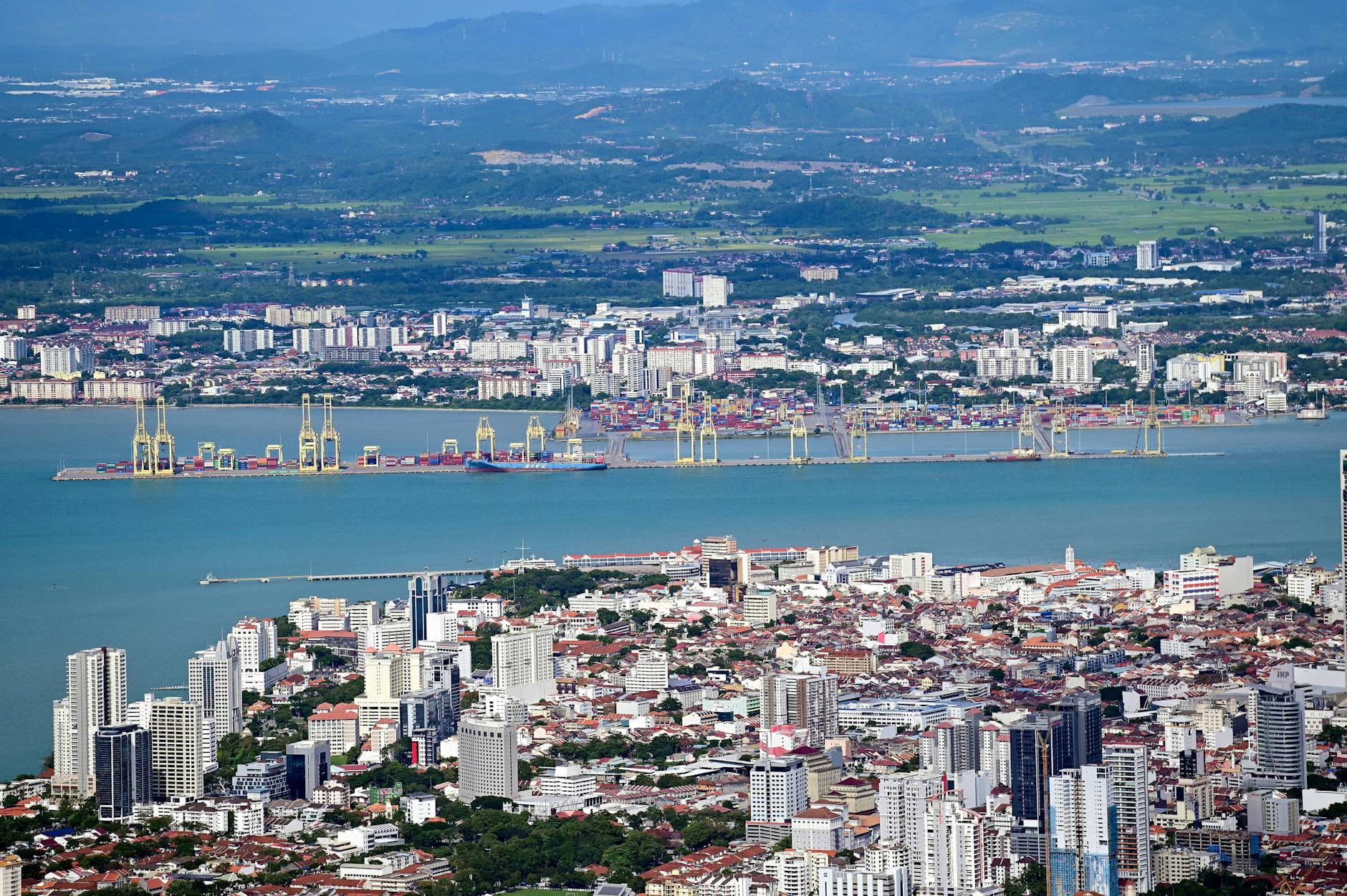Stunning aerial view of George Town cityscape with bustling port in Penang, Malaysia.