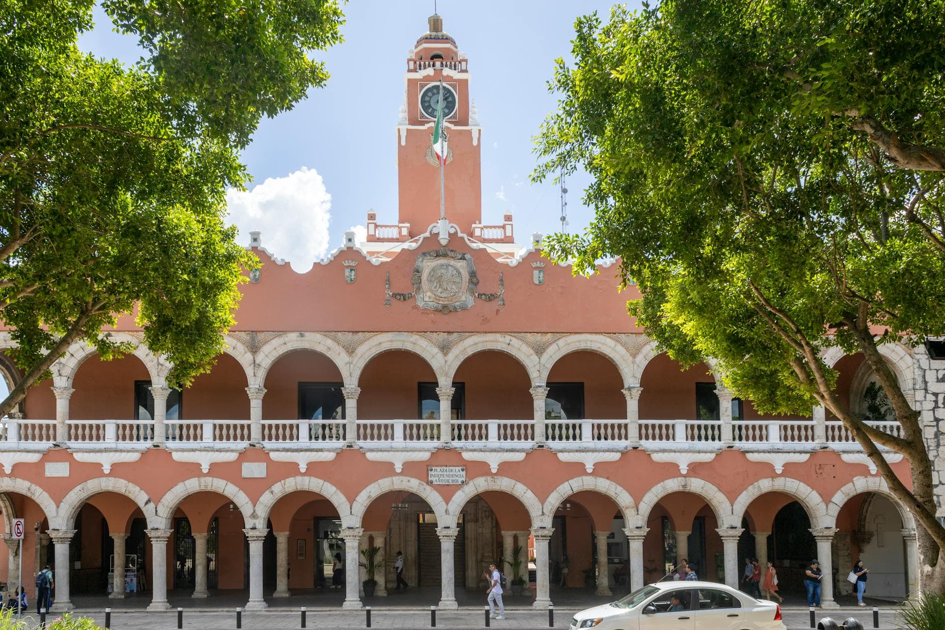 Historic colonial building with arches and a clock tower in Mérida, Yucatán, Mexico.
