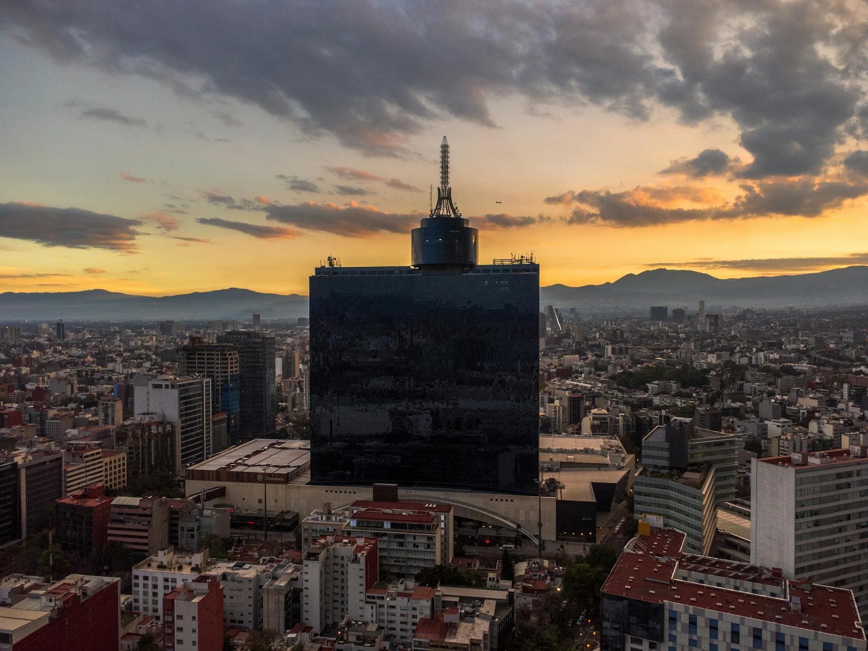 Stunning aerial view of Mexico City skyline with iconic buildings at sunset.