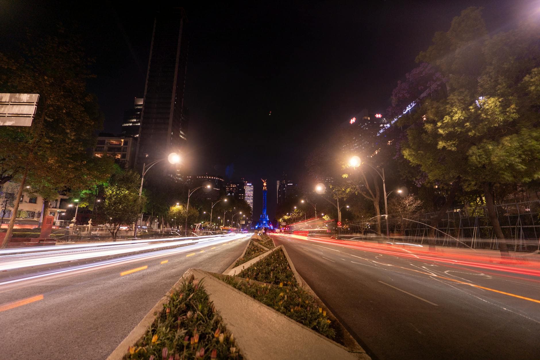 Captivating night scene of bustling traffic and the Angel of Independence on Paseo de la Reforma, CDMX.
