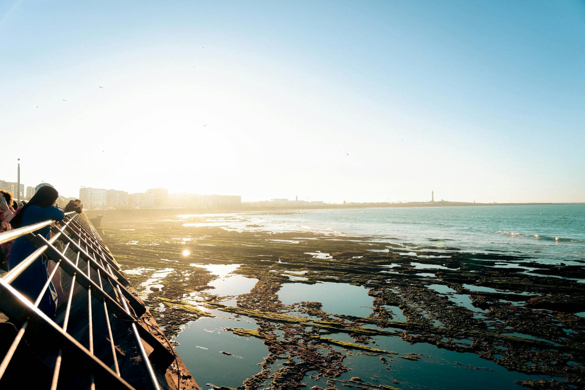 Scenic sunset view by the Casablanca coast with people enjoying the sea breeze.