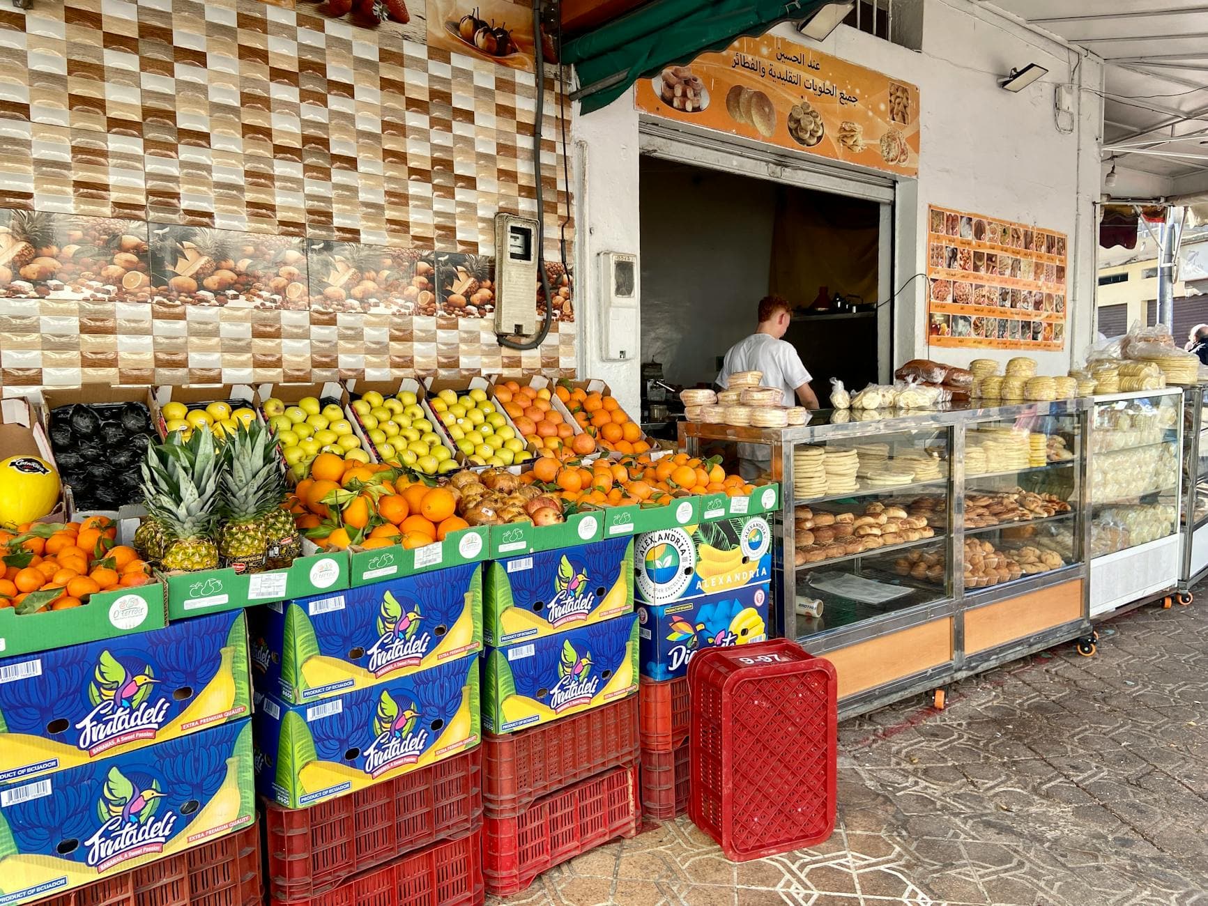 Colorful fruits and pastries displayed at a Casablanca street market.