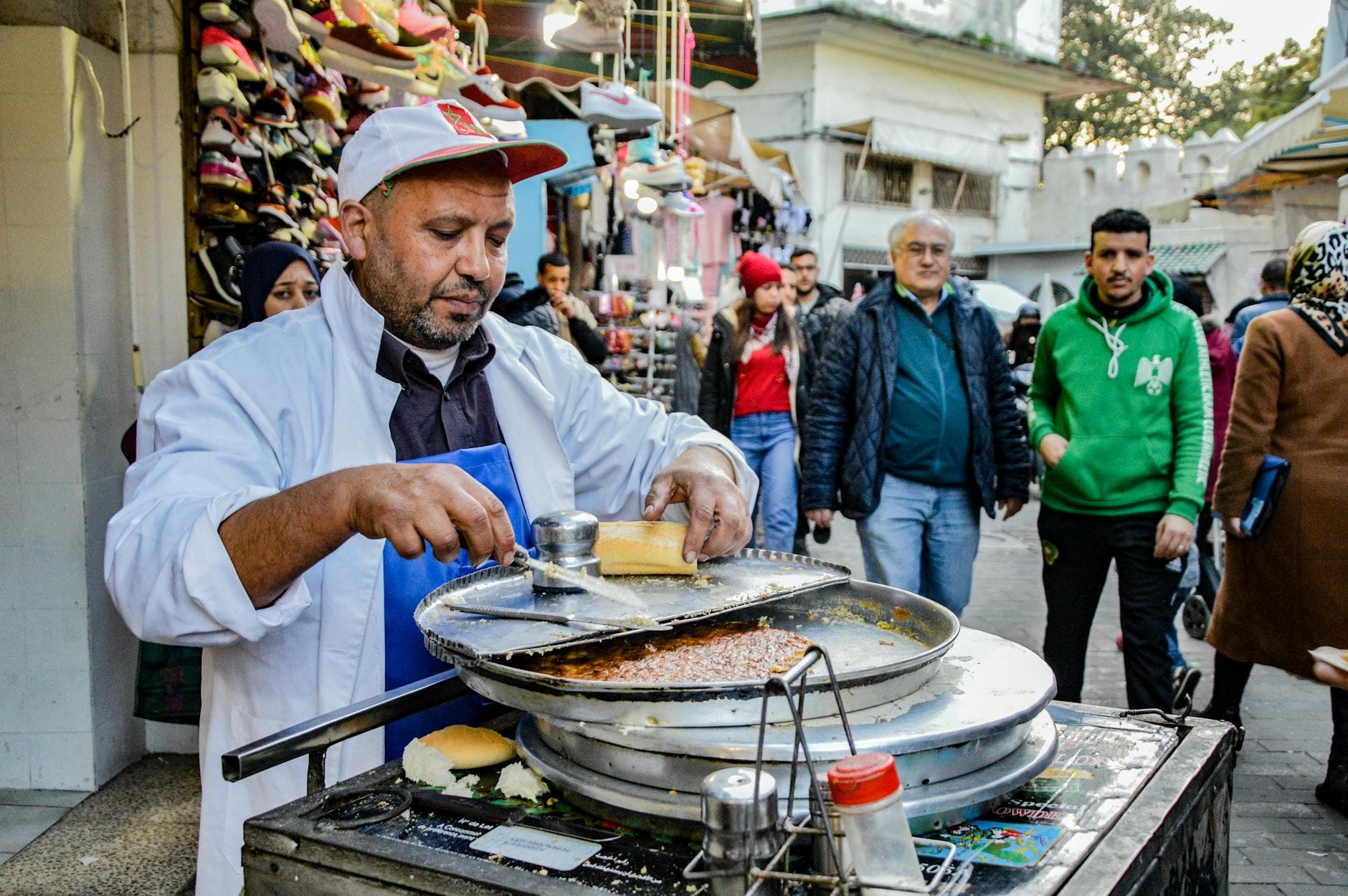 A street vendor prepares food in the bustling market of Tangier, Morocco.