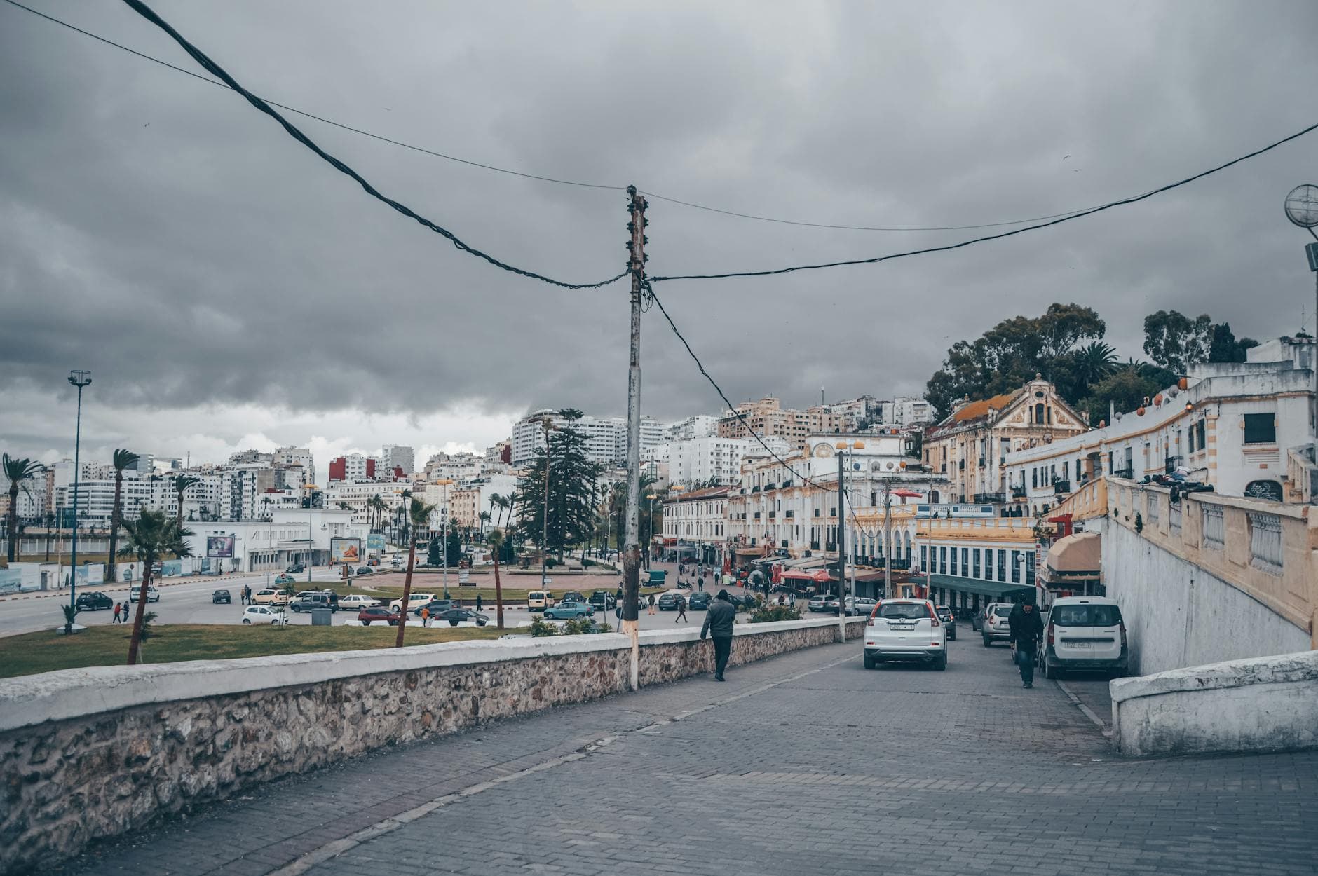 Overcast day in Tangier, Morocco, showcasing urban buildings and street life.