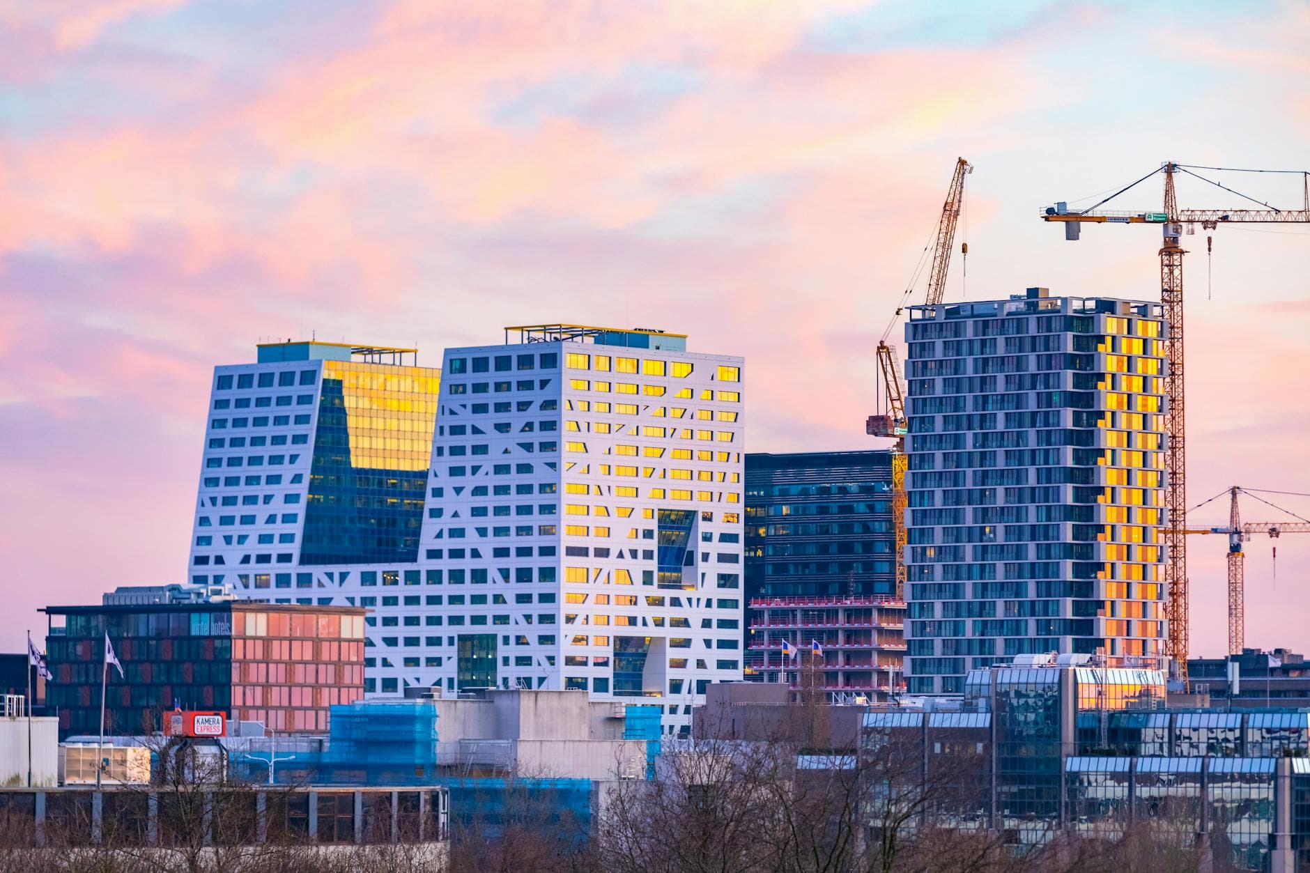 Utrecht cityscape featuring contemporary architecture at sunset.