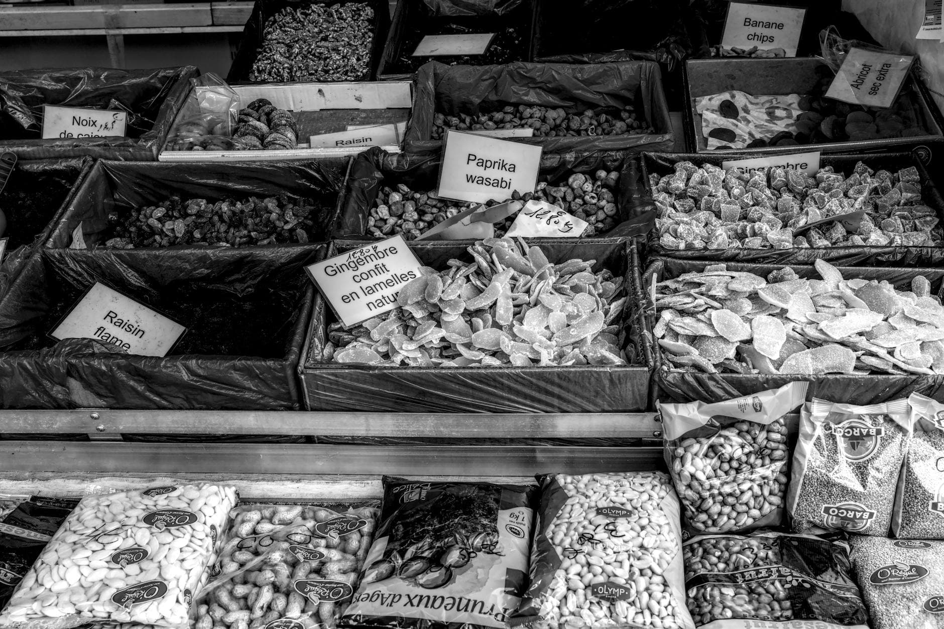 Black and white image of assorted dried foods at a market stall in Vaison-La-Romaine, France.