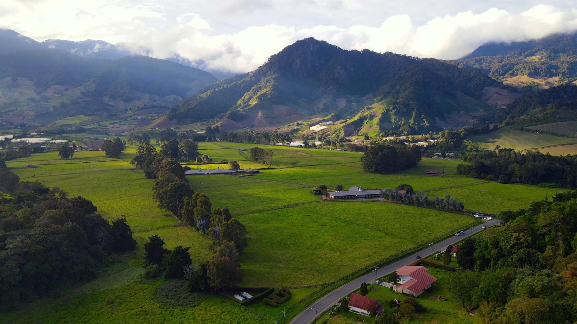 Aerial landscape of lush green fields and mountains in Cerro Punta, Panama.