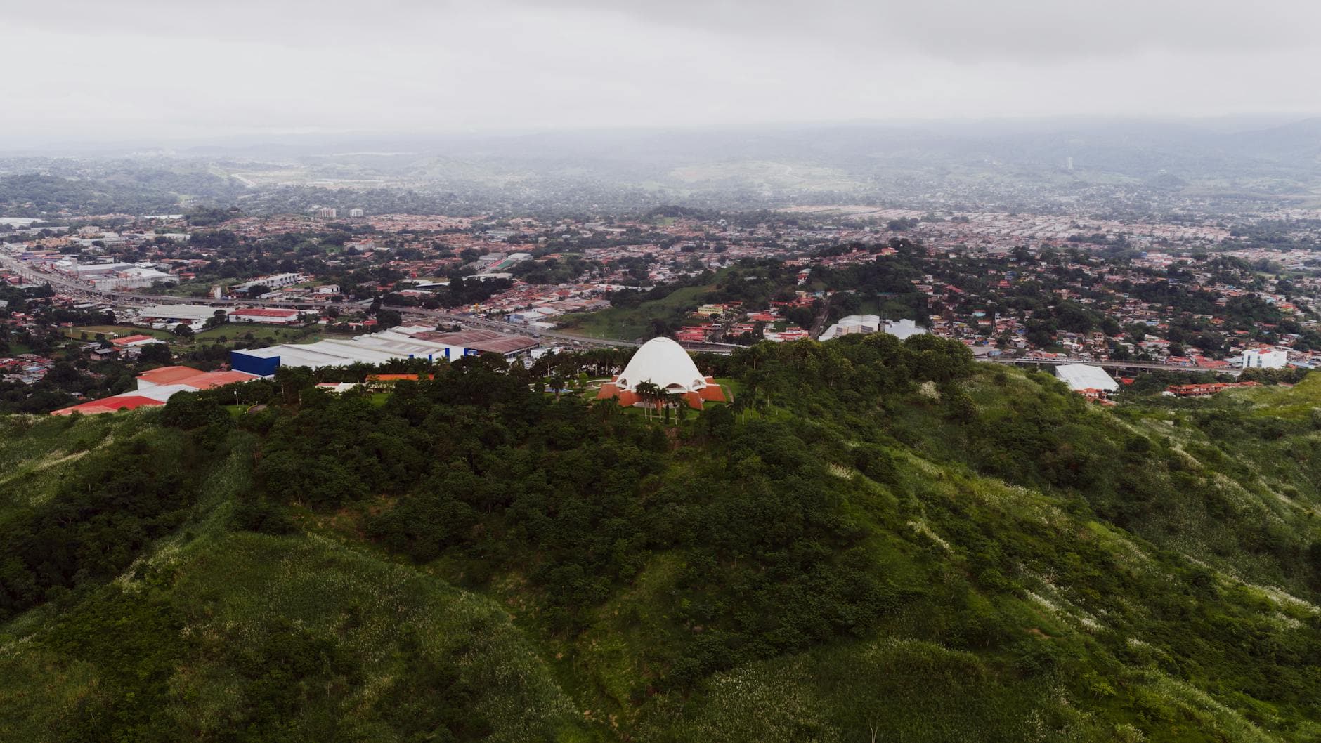 A stunning aerial view of Panama City with lush green hills and urban landscape.