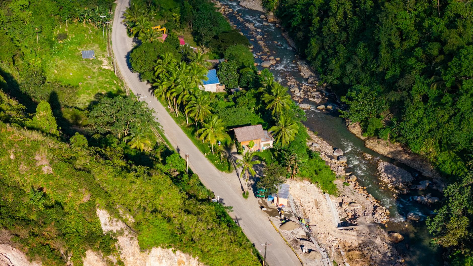 A breathtaking aerial shot capturing the lush countryside, winding river, and road in Cebu, Philippines.