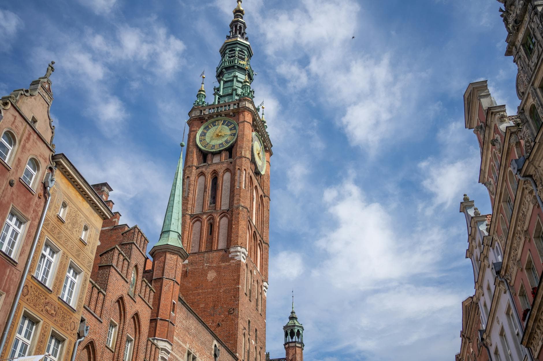 View of Gdańsk Town Hall's historic architecture on a sunny day with clear blue skies.