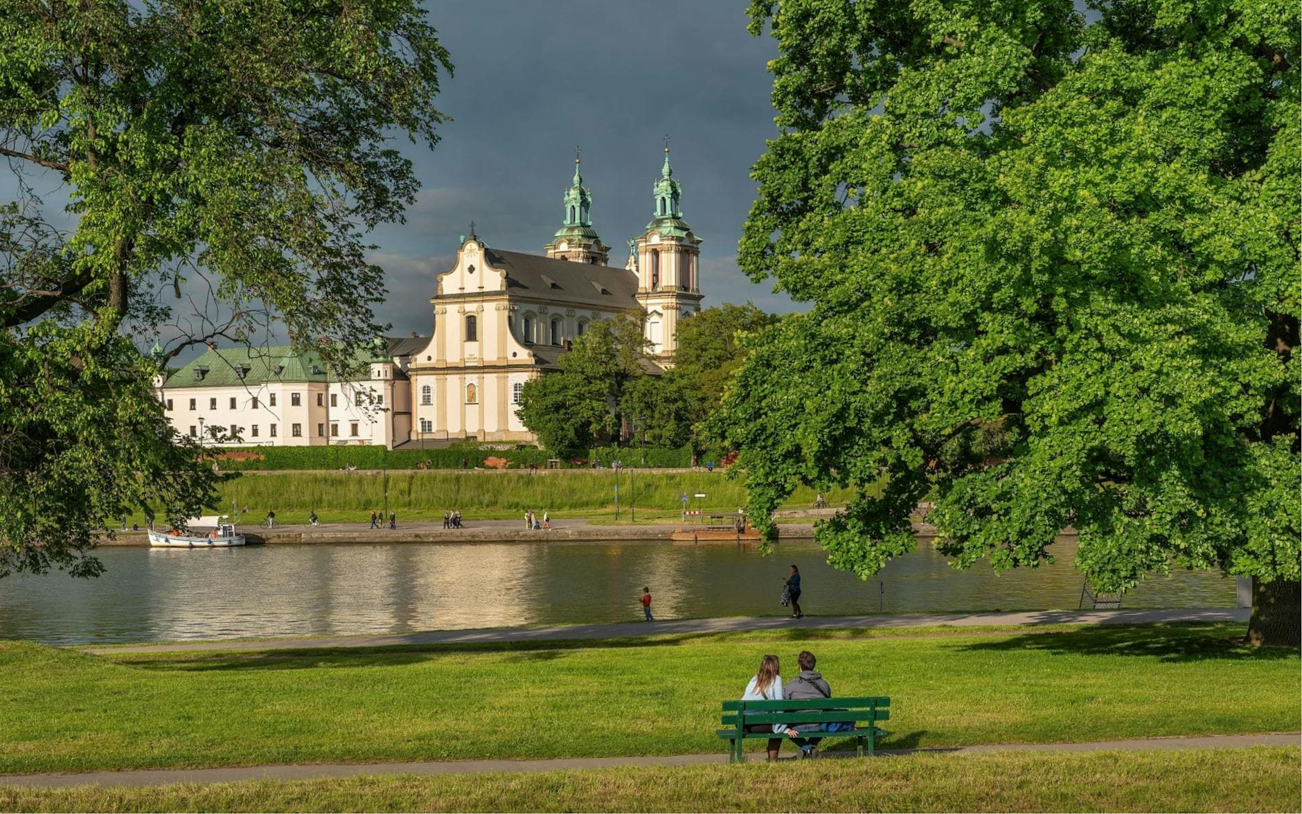 Scenic view of the Vistula River and Church of St. Joseph in Kraków, Poland.