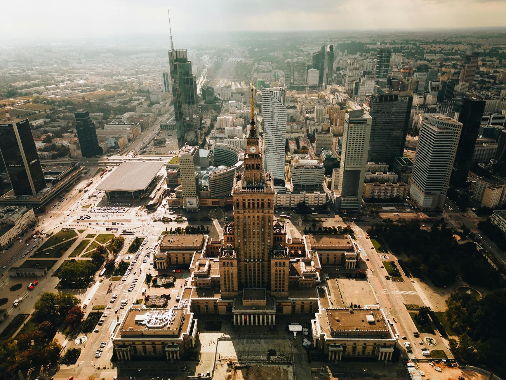 Stunning aerial shot of Warsaw featuring the Palace of Culture and Science amid modern skyscrapers.