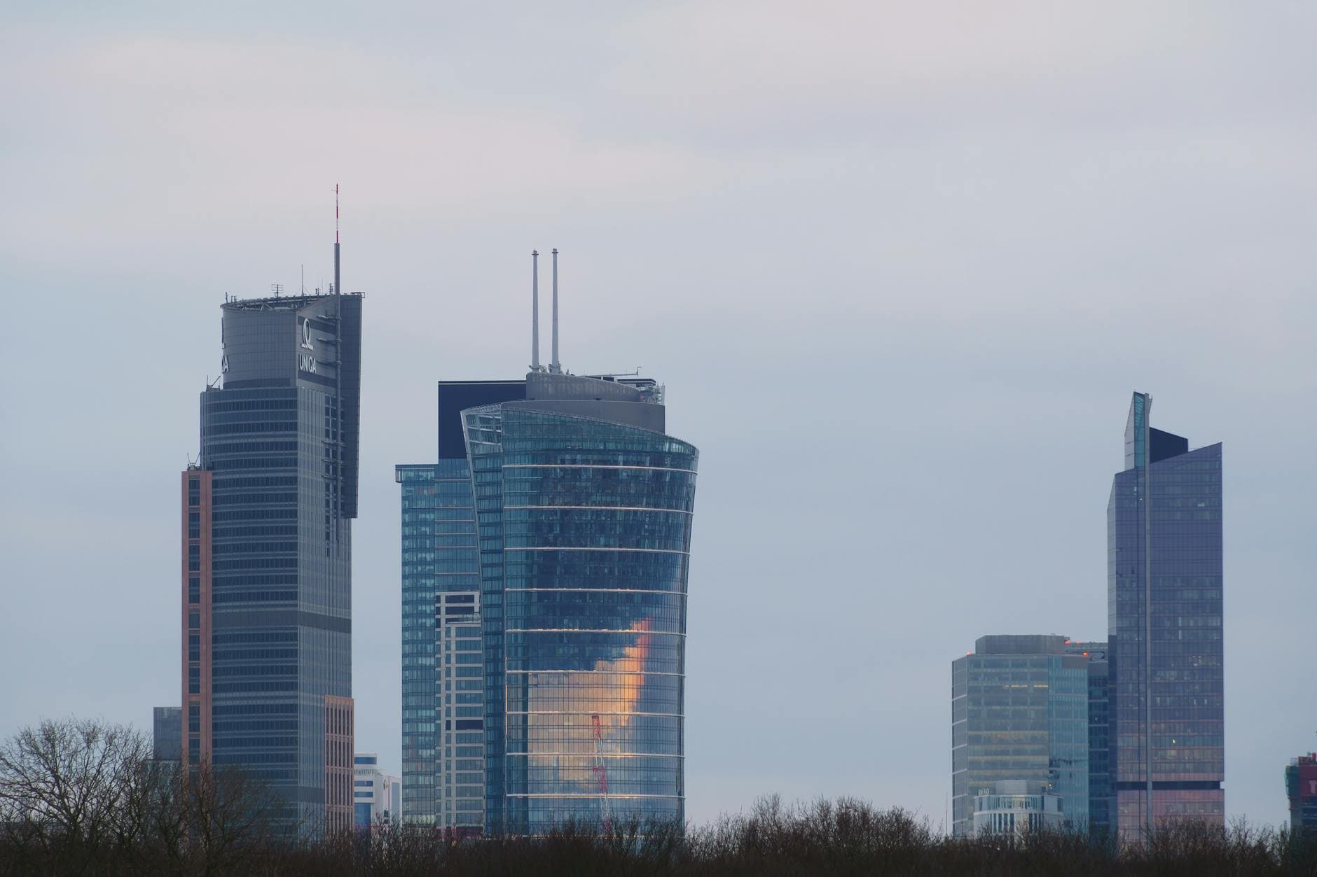 Modern skyscrapers dominate the Warsaw skyline. Twilight view offers a serene cityscape.