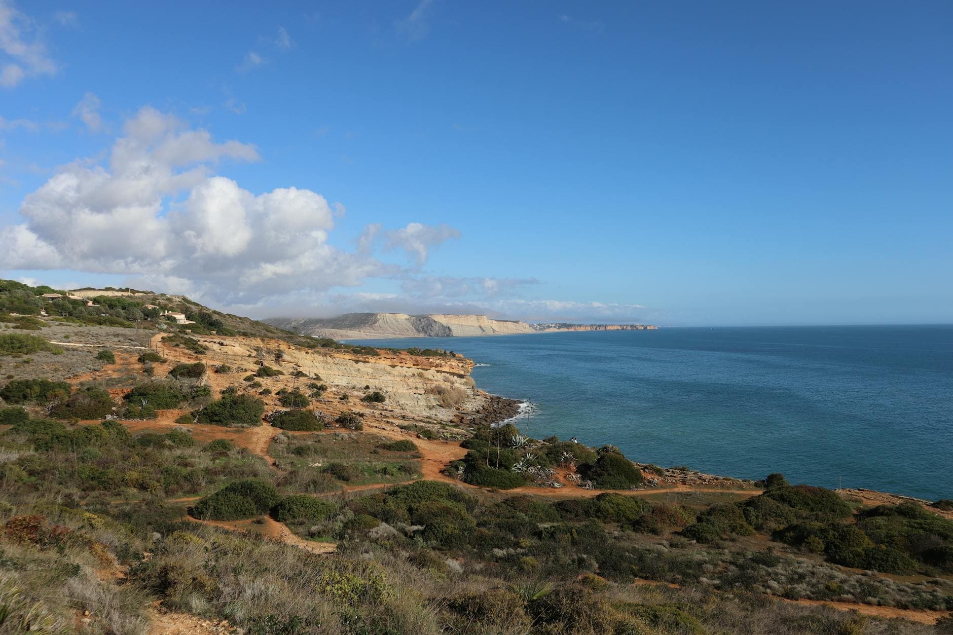 Beautiful view of the Algarve coastline with cliffs and ocean under a clear blue sky.