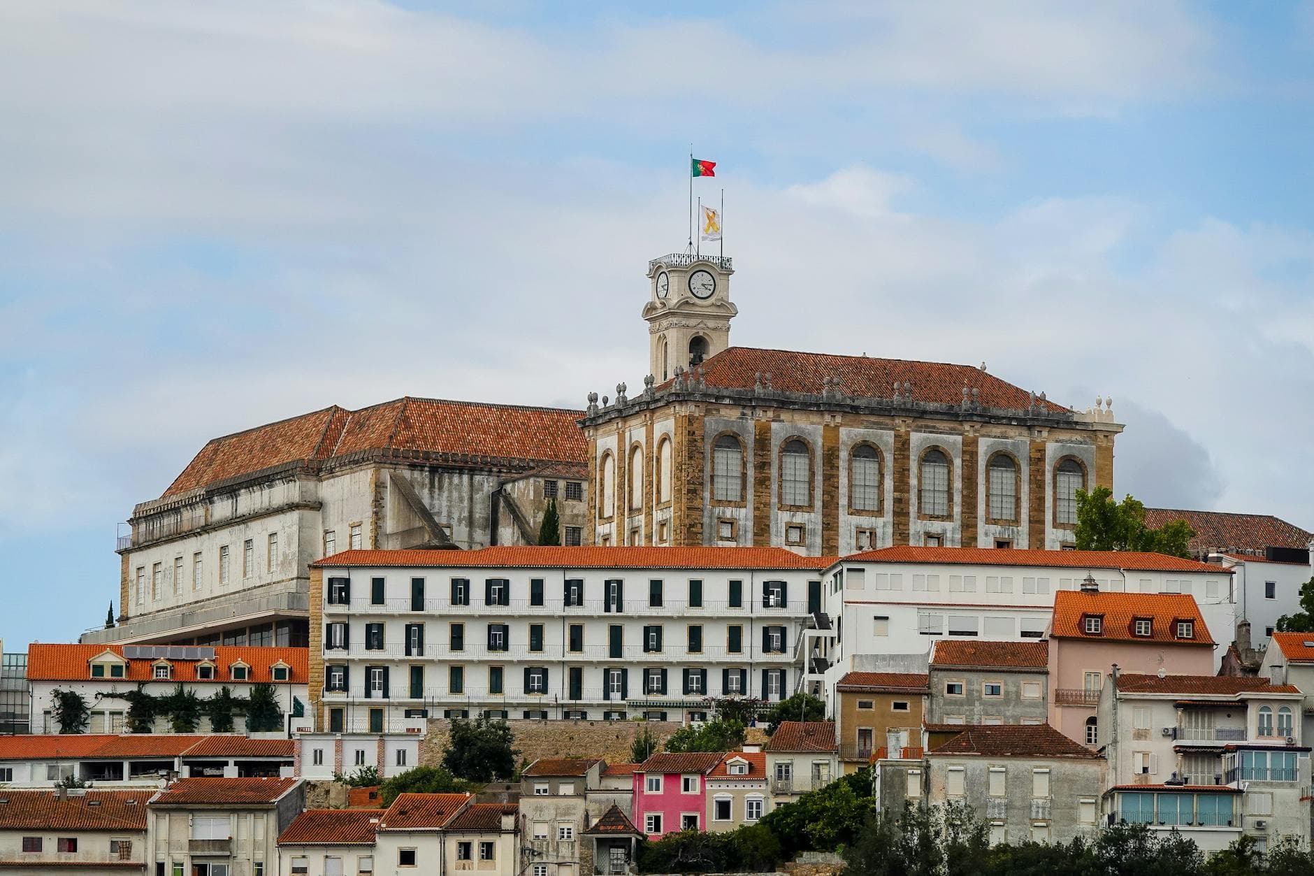 Historic architecture of the University of Coimbra, Portugal, showcasing classical design and a prominent clock tower.
