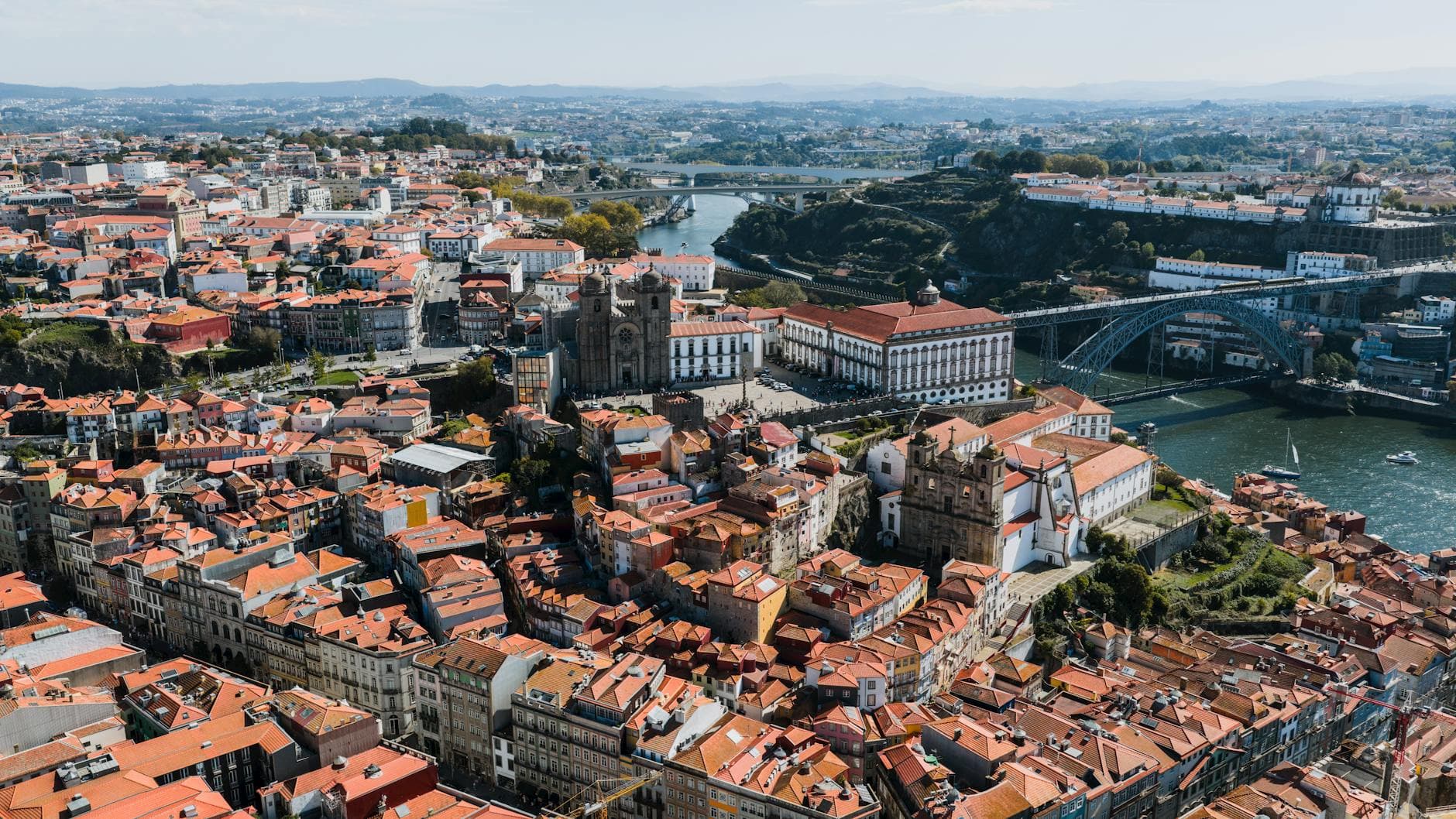Stunning aerial photograph showcasing the cityscape of Porto, Portugal with the iconic Douro River and historical architecture.