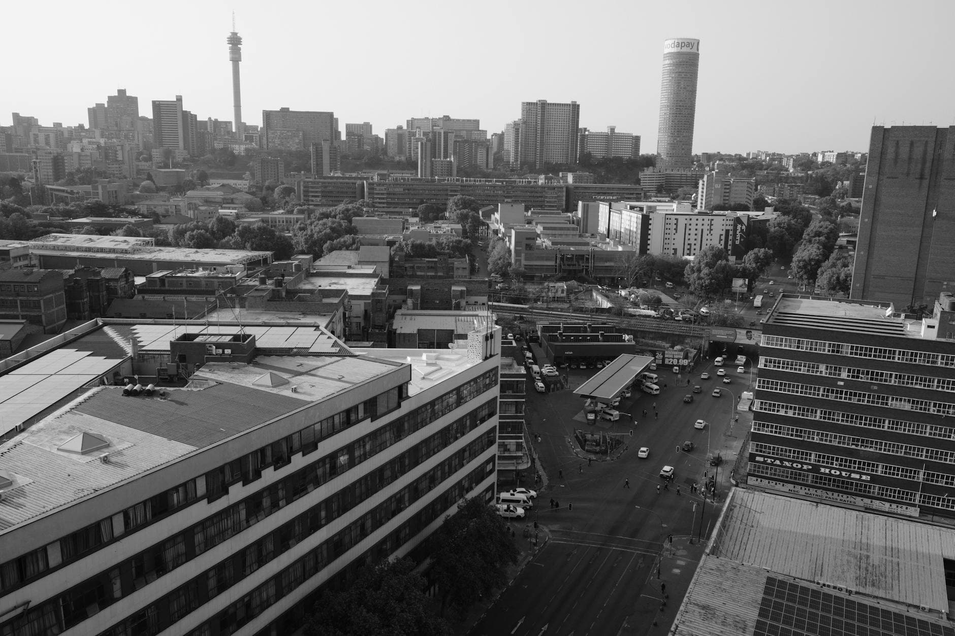 Aerial view of Johannesburg's skyline in black and white, showcasing iconic skyscrapers.