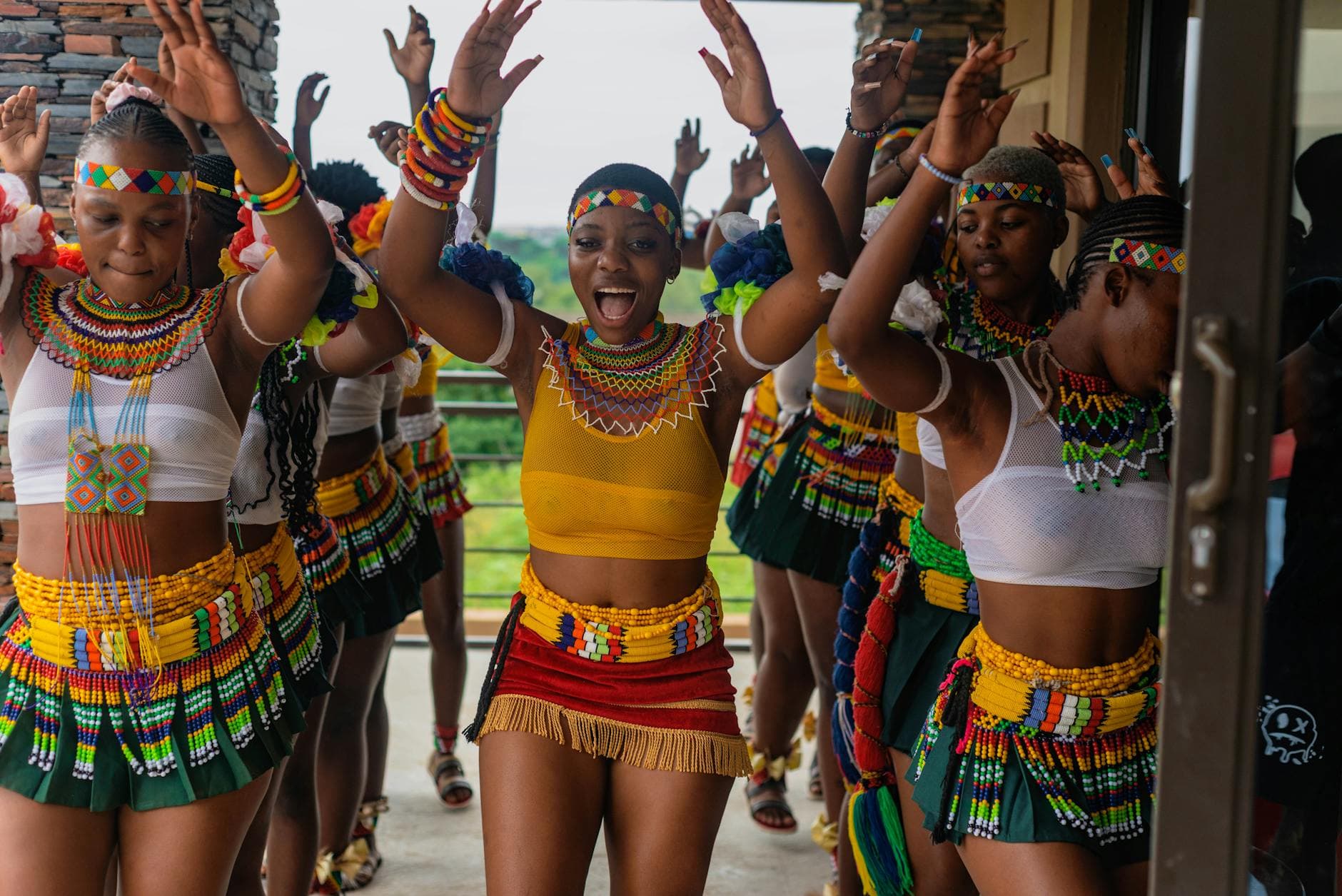Vibrant group of women performing a traditional Zulu dance in colorful attire, showcasing rich African culture.
