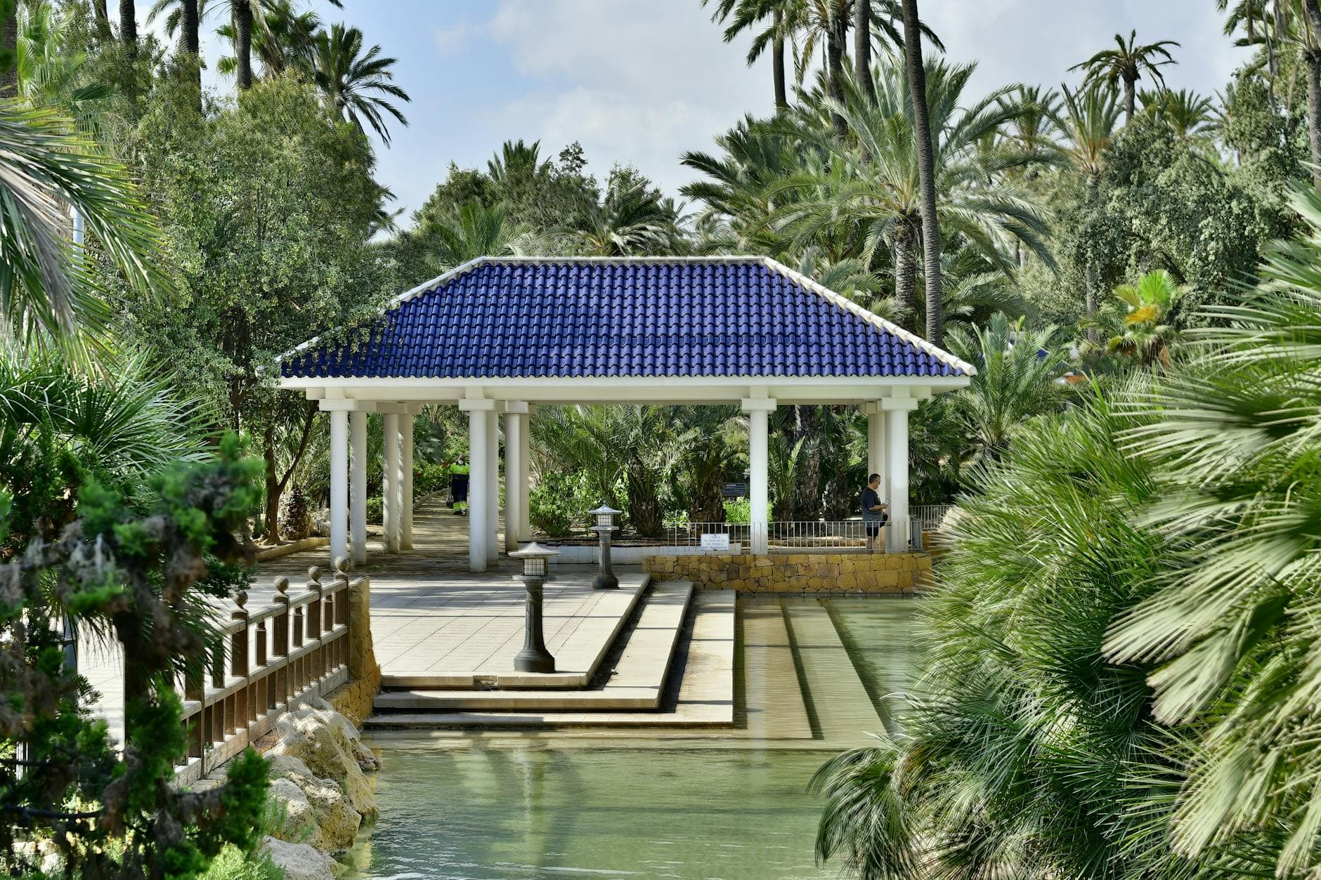 Tranquil garden view with a blue-roofed gazebo, ideal for relaxation in Alicante.
