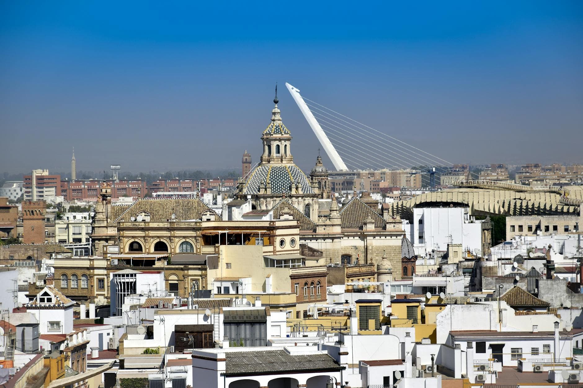 Elevated view of Sevilla's skyline showcasing historic architecture and the Puente del Alamillo.