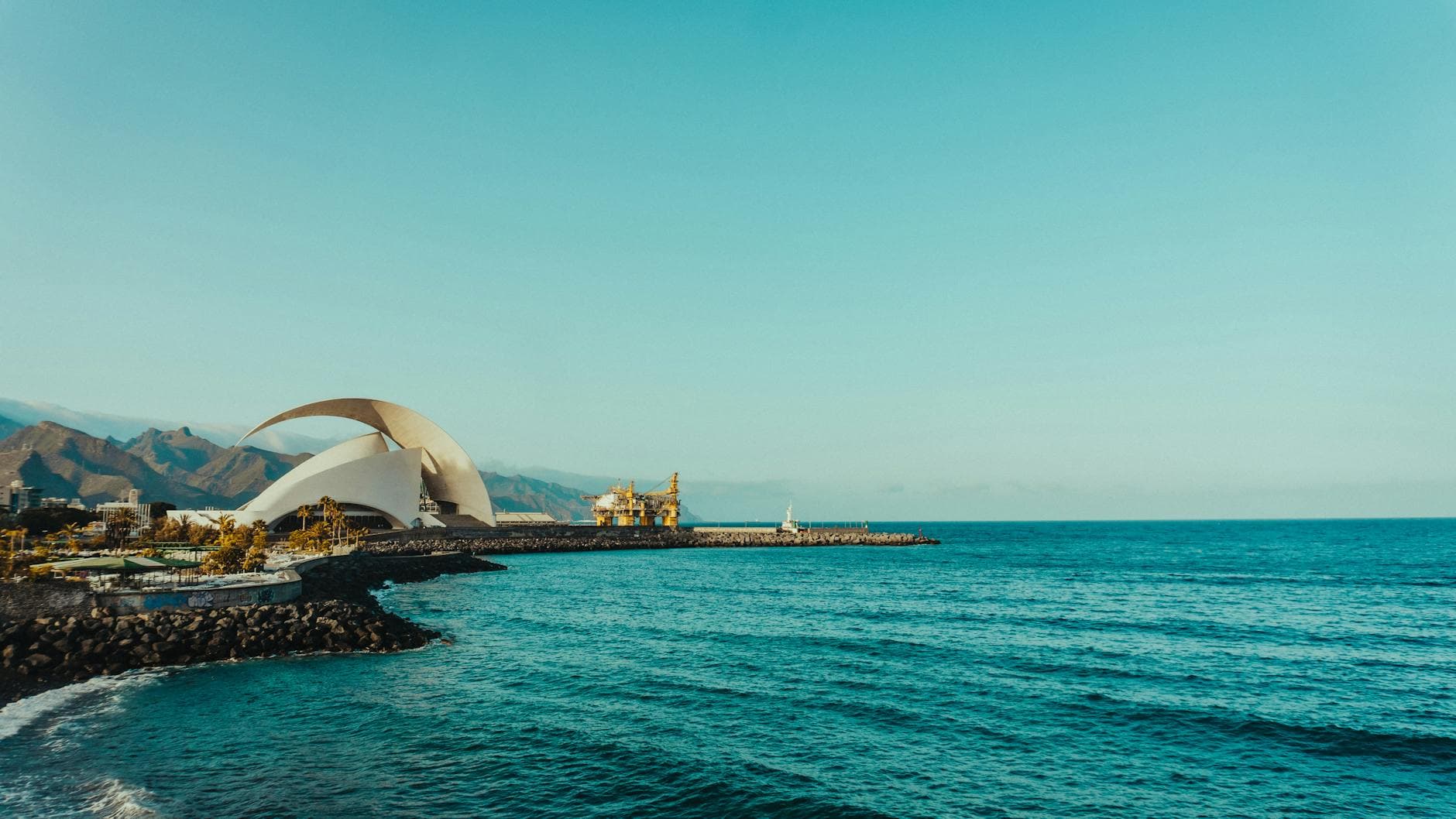 Explore the stunning coastline of Tenerife with the iconic Auditorio de Tenerife by the sea.
