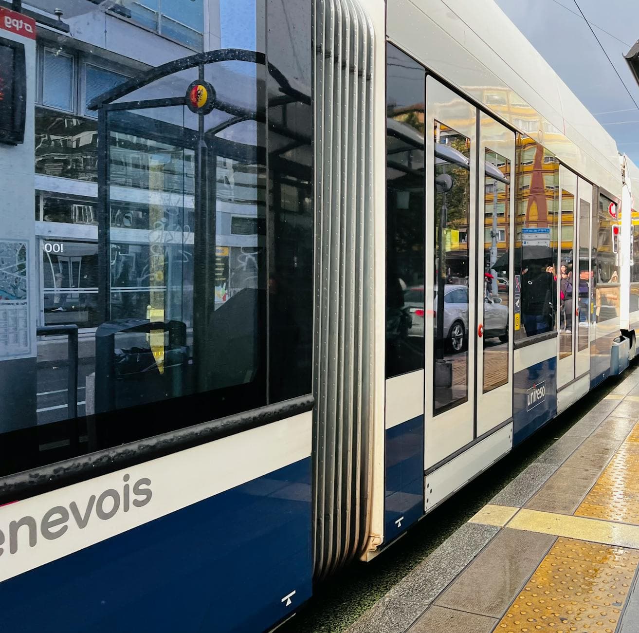 A sleek tram in Geneva, Switzerland, reflecting the bustling urban life.