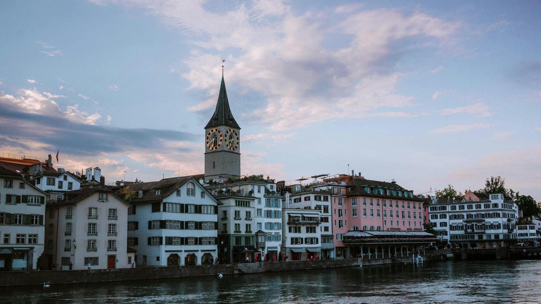 Beautiful view of St. Peter's Church and waterfront architecture in Zürich, Switzerland.