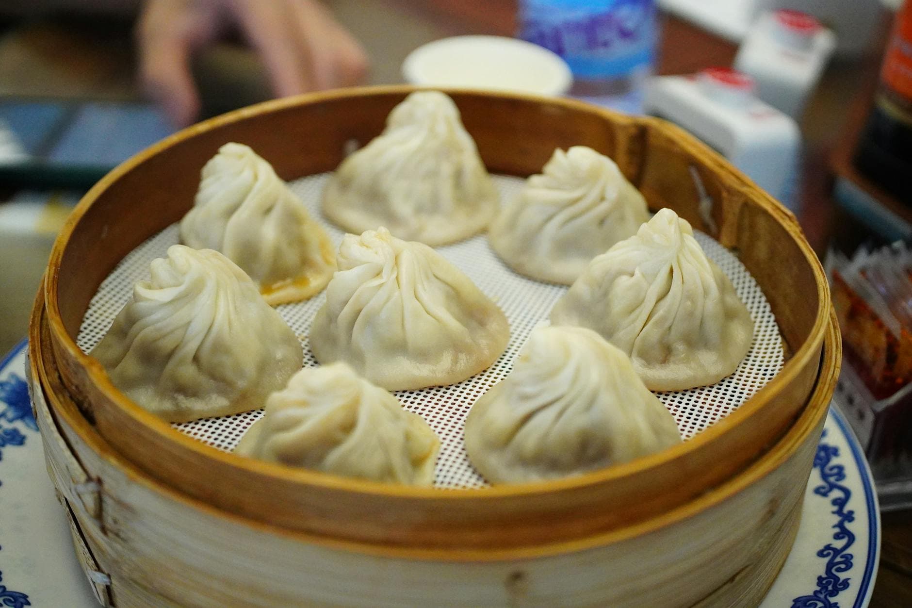 Delicious steamed dumplings served in a bamboo basket, perfect for a traditional Chinese meal.