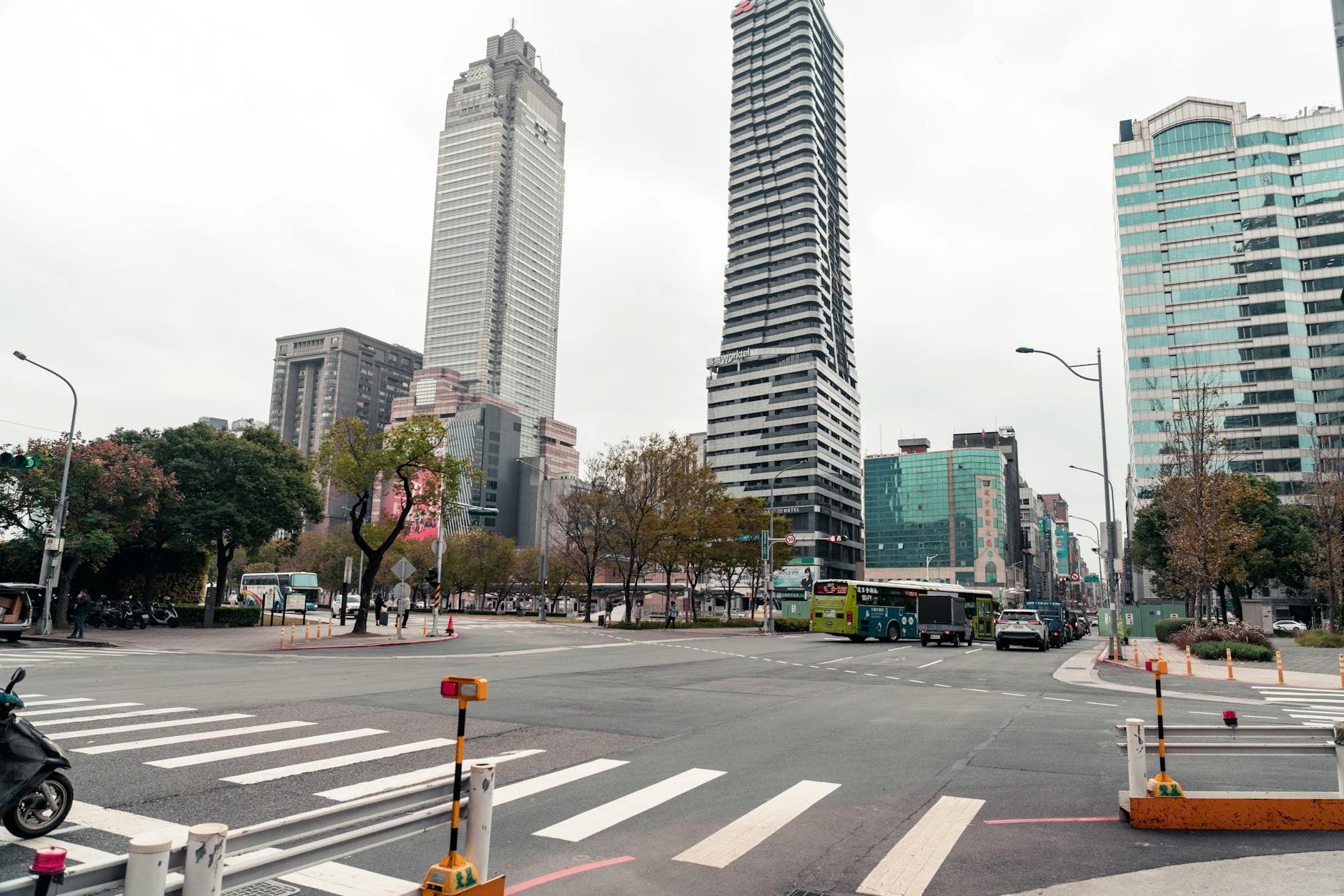 A bustling intersection in Taipei, Taiwan, showcasing modern skyscrapers and city life.