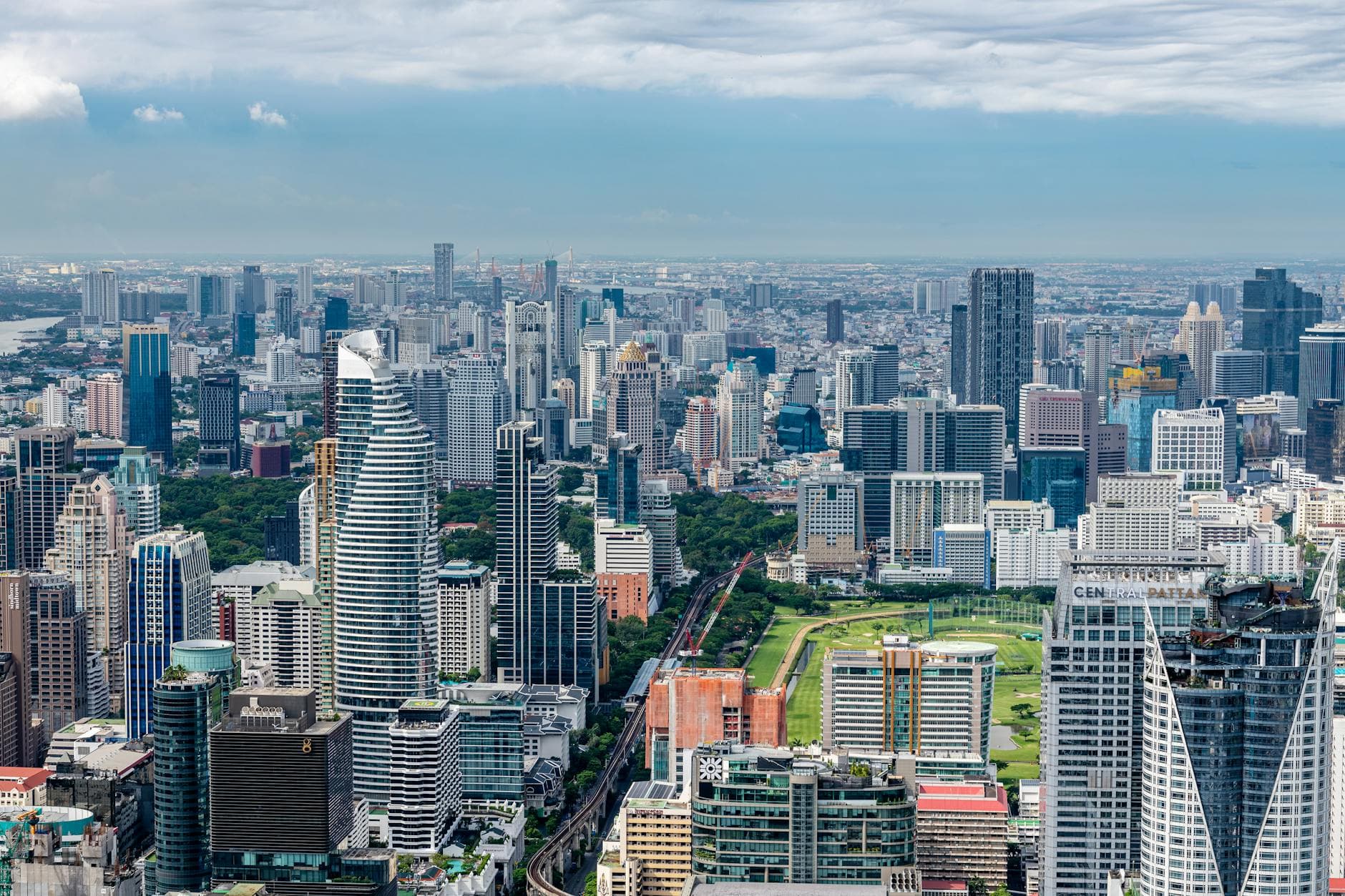 High-angle panoramic view of Bangkok's modern skyline showcasing skyscrapers and urban architecture.