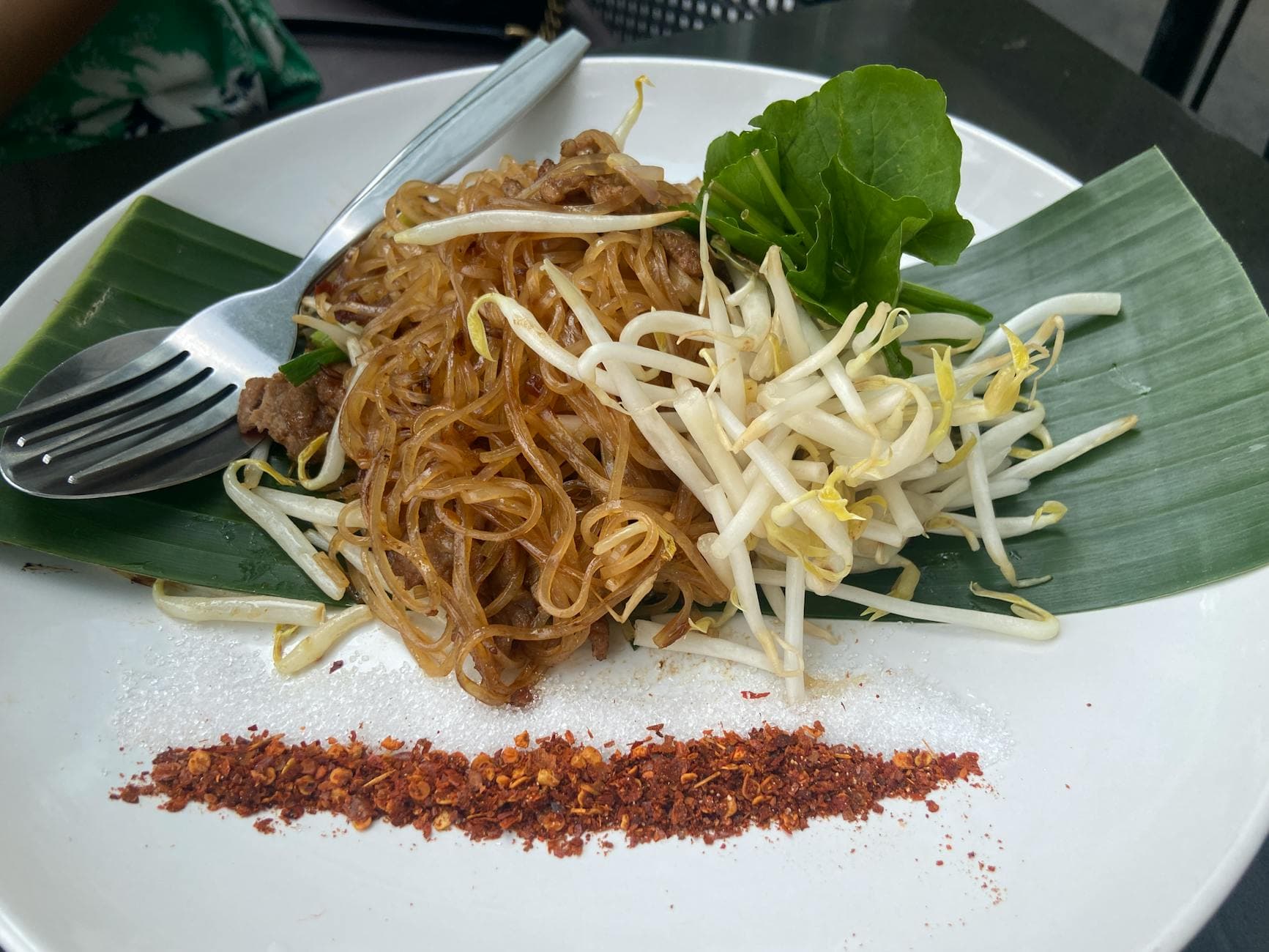 Close-up of traditional Pad Thai noodles garnished with sprouts and chili in Bangkok, Thailand.