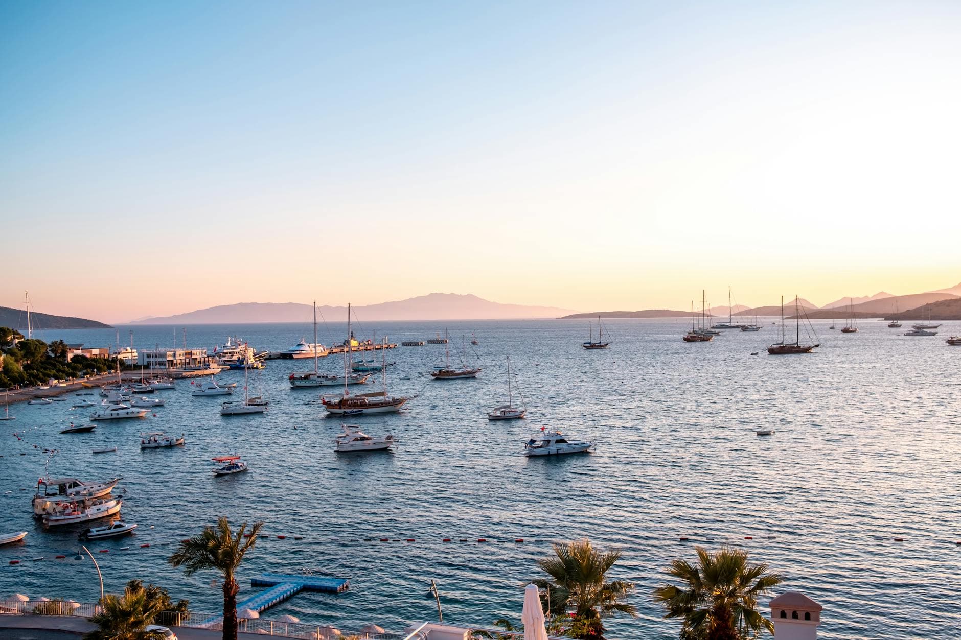 Beautiful view of boats in Bodrum harbor, Türkiye during sunset with ample copy space.