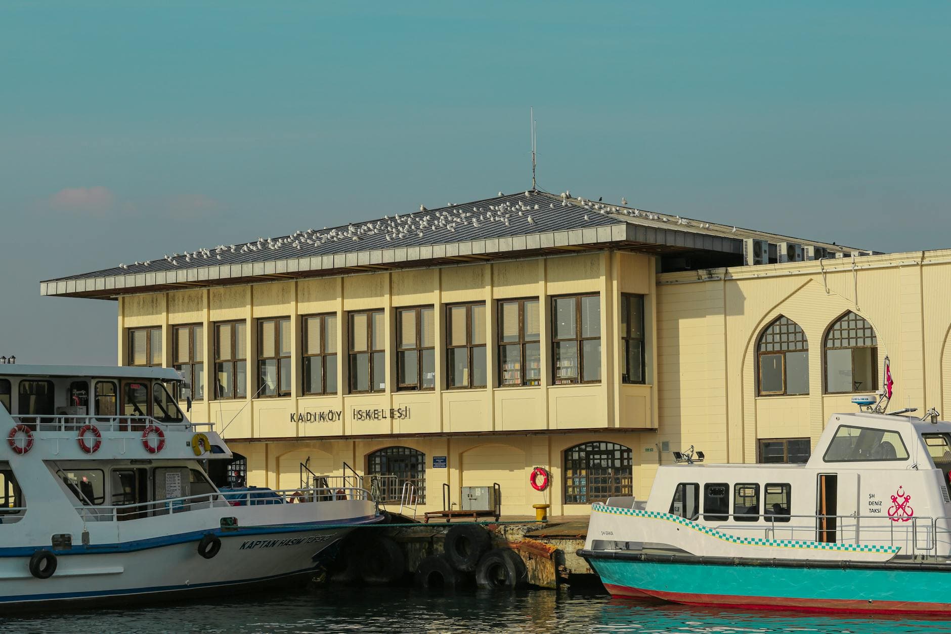 Scenic view of Kadikoy Pier and ferries in Istanbul, capturing urban waterfront life.