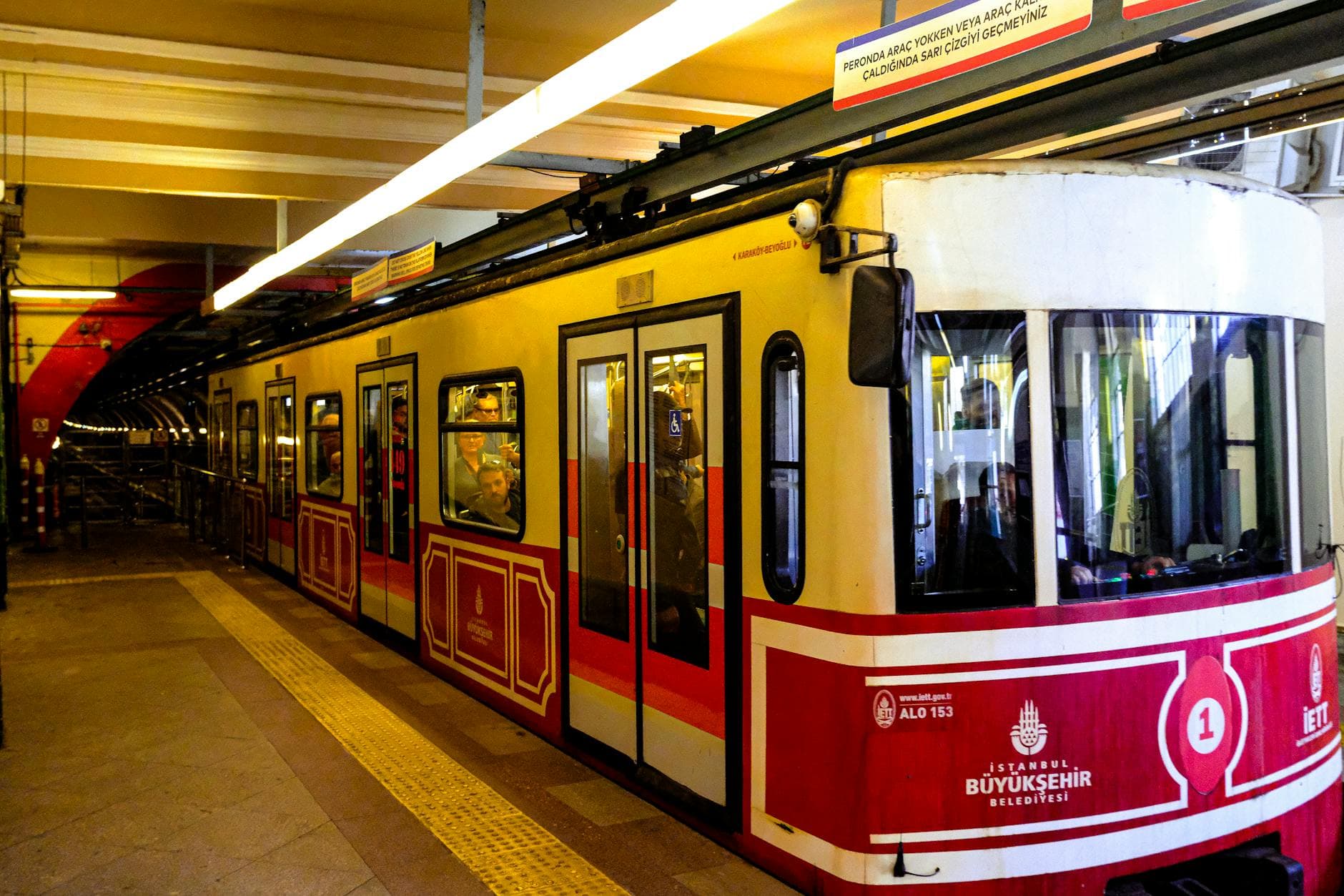 Explore the vibrant red funicular at Istanbul's iconic underground tunnel station.