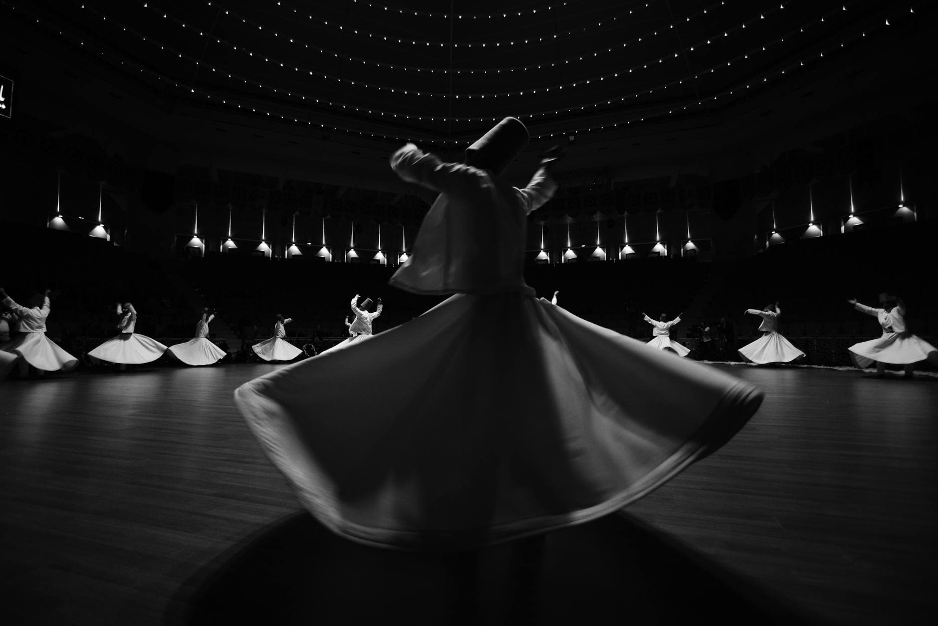 Captivating black and white image of whirling dervishes performing in Konya, Türkiye.
