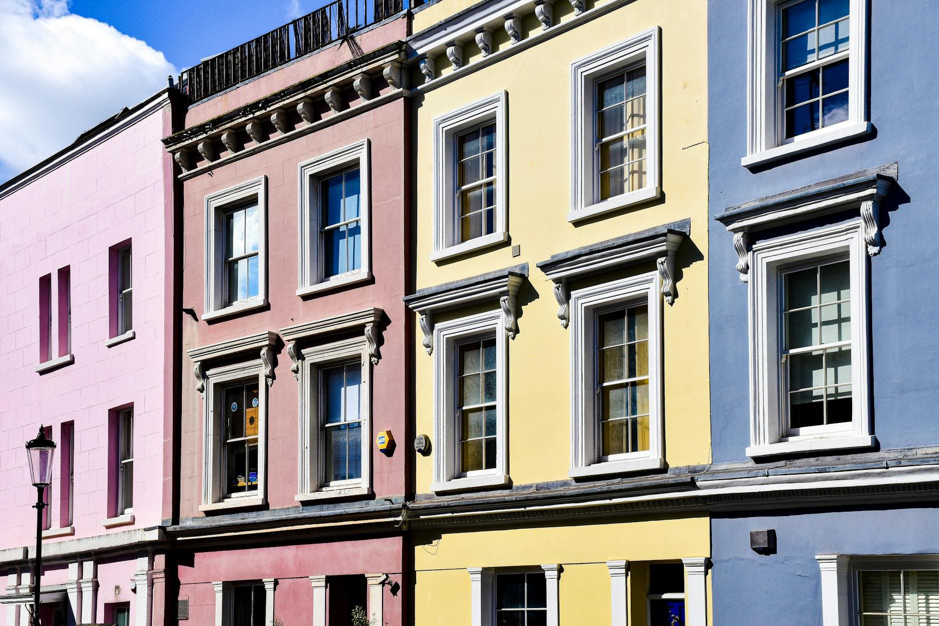 Vibrant, multi-colored houses in Notting Hill, London, showcasing urban charm.